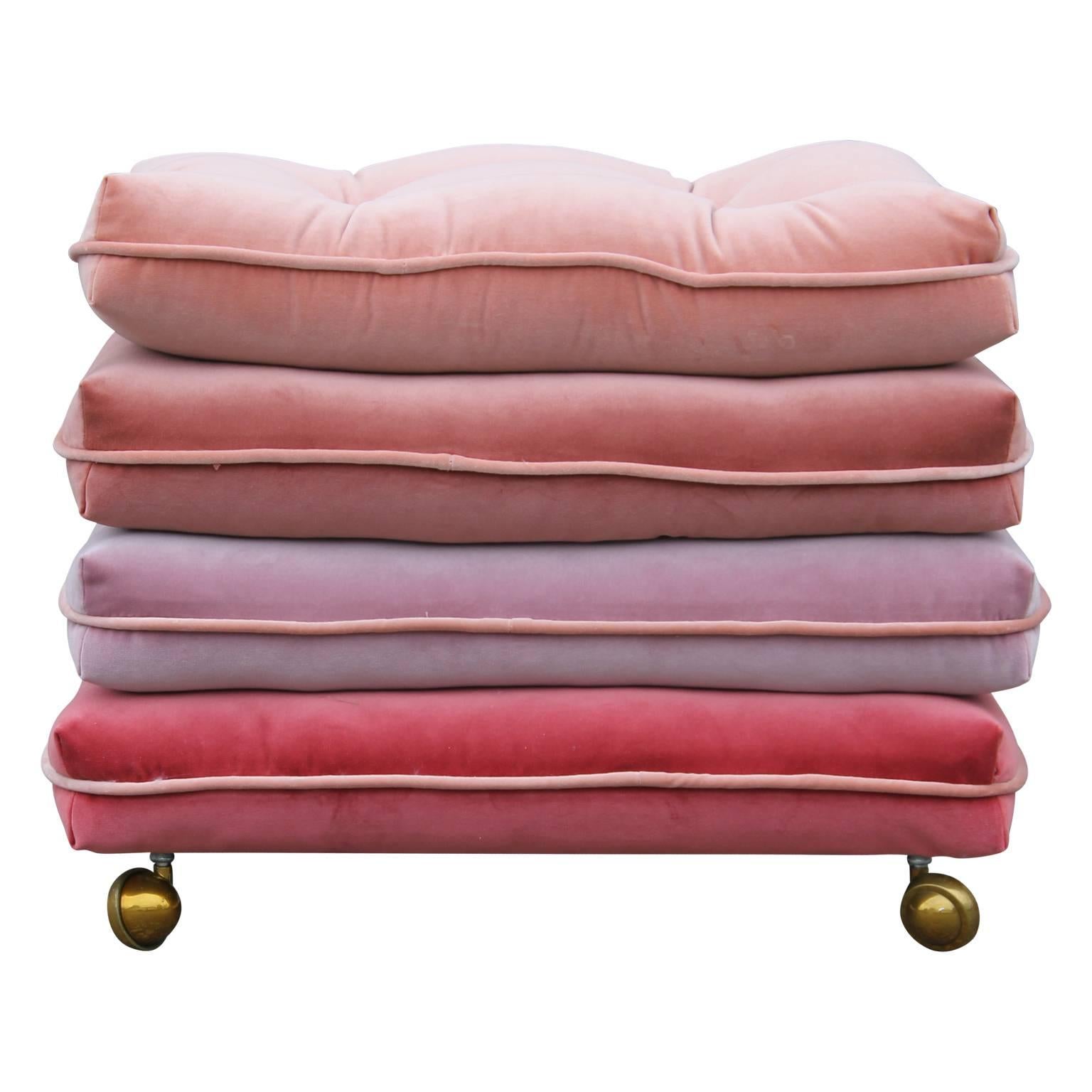 Pair of custom-made stacked pillow cushion stools made from four different shades of pink creating a lovely ombre or gradient effect. Outfitted on brass casters. 

We can also make them custom COM.