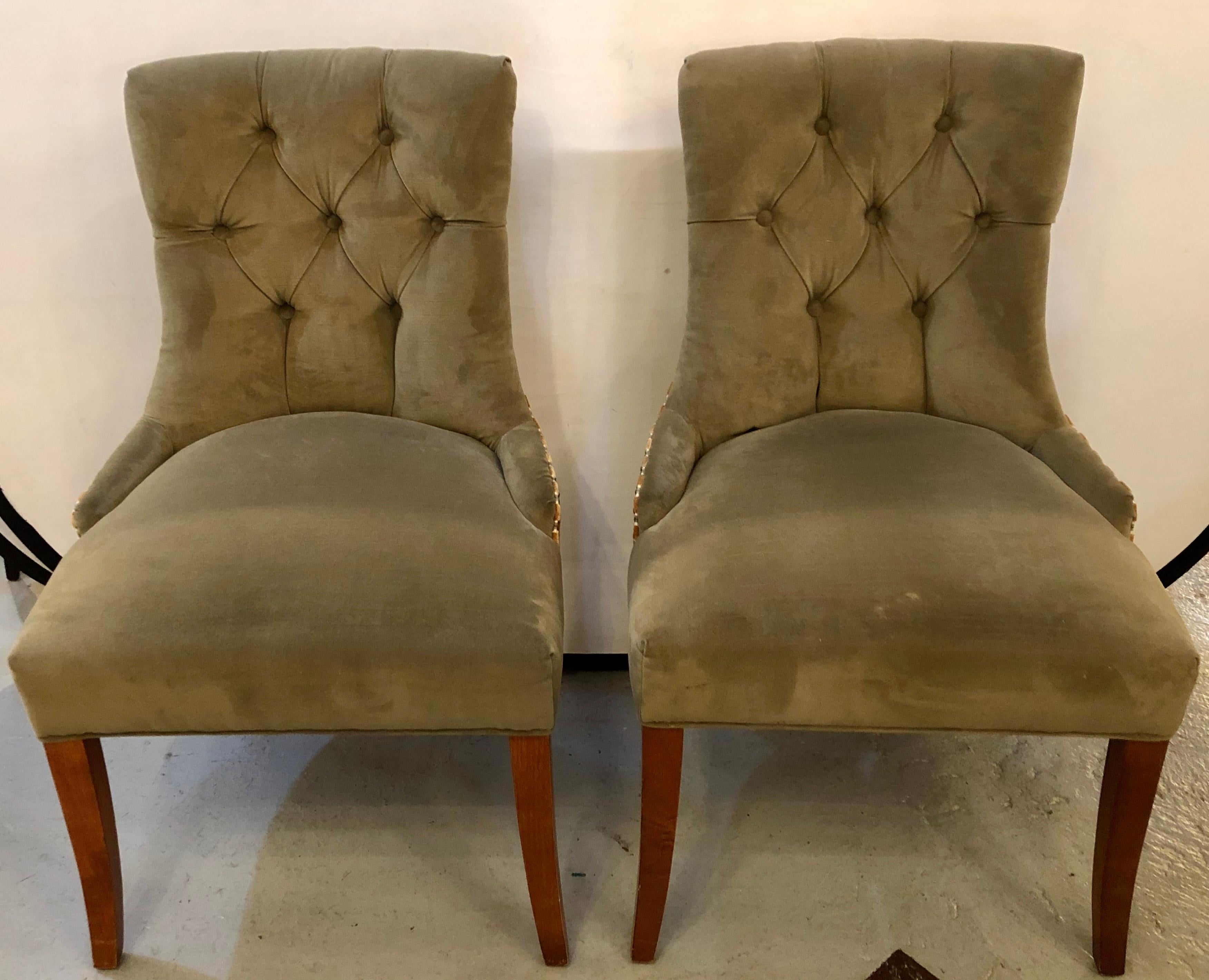 Pair of custom quality finely upholstered side / desk chairs. Each having a clean tufted back with a stripped reverse having a handle. The pair nicely tacked on sprayed legs. Strong and study. Would make a Fine addition to any desk, office or room