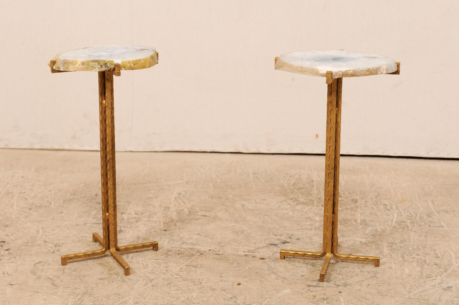 A pair of custom drinks tables with quartz tops. This pair of drinks tables have been fashioned from cut slabs of quartz which have been re-purposed as tops and set onto iron bases. The custom iron bases, gold in color, are clean lines with