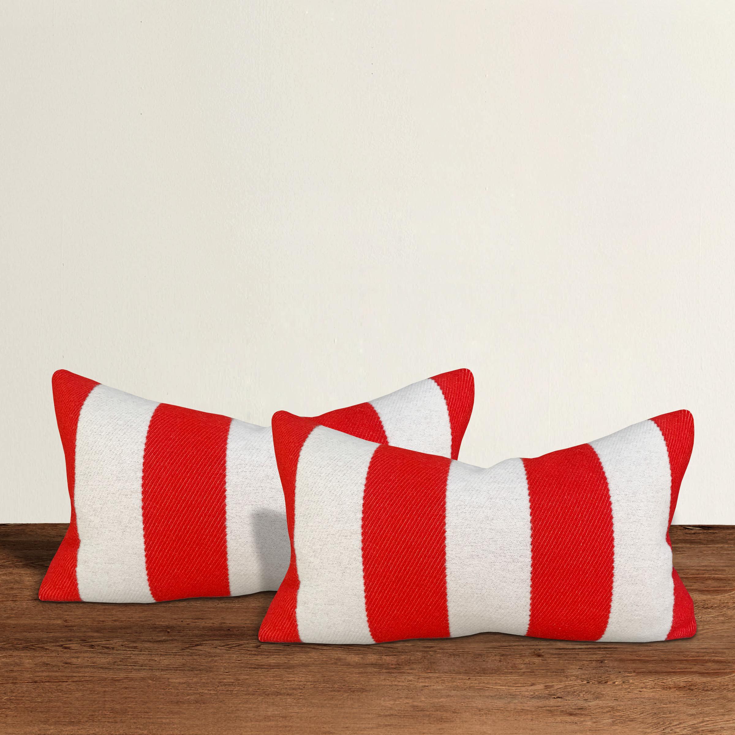 A wonderful pair of lumbar pillows with wide red and white stripes on one side, and solid blue on the other, custom made from wool sourced from the Faribault Woolen Mills in Faribault, Minnesota. Faribault Woolen Mills was founded in 1865 along the