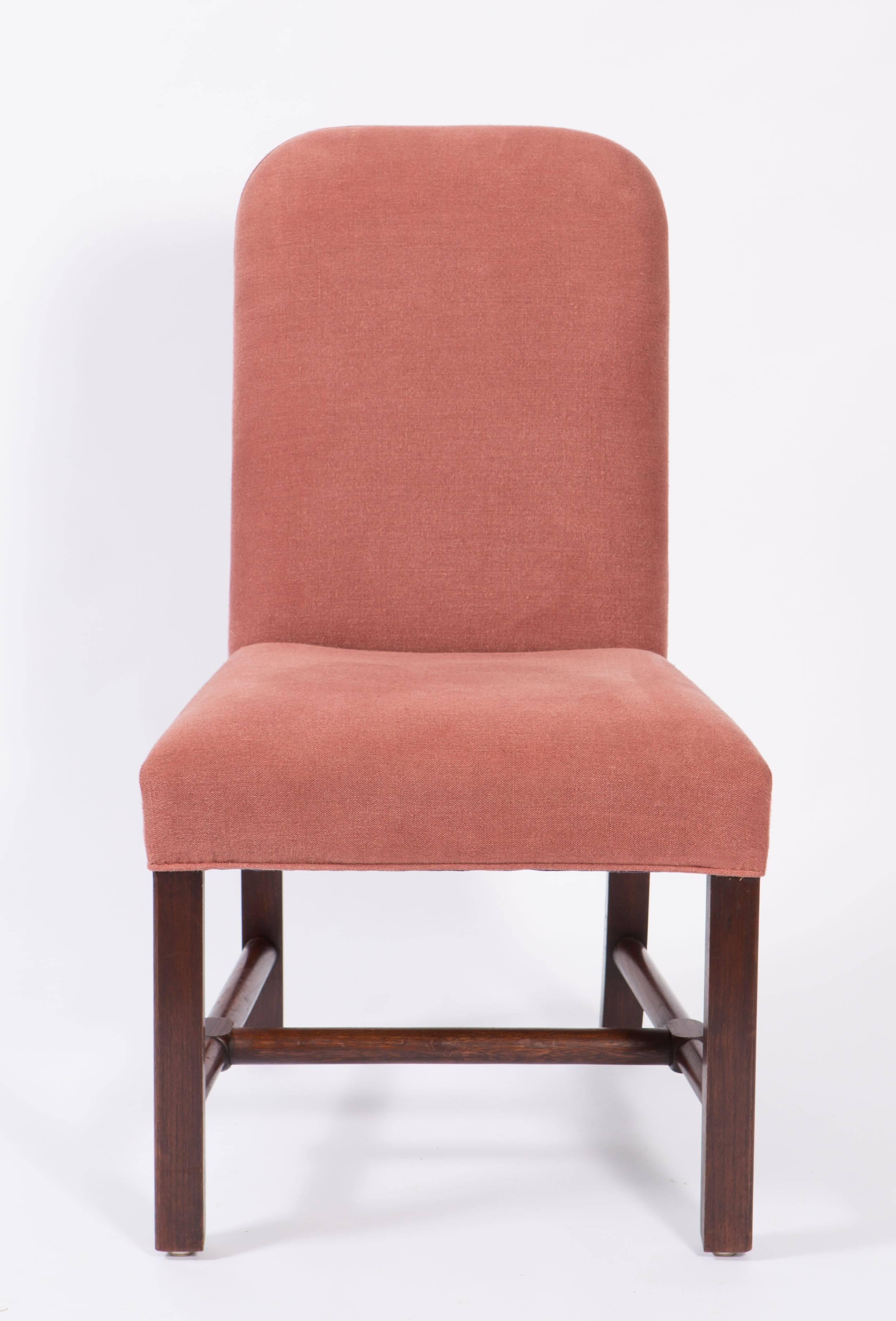 Upholstered pair of side chairs purchased from Axel Vervoordt covered in dusty mauve linen with dark stained legs. They are in excellent condition. 