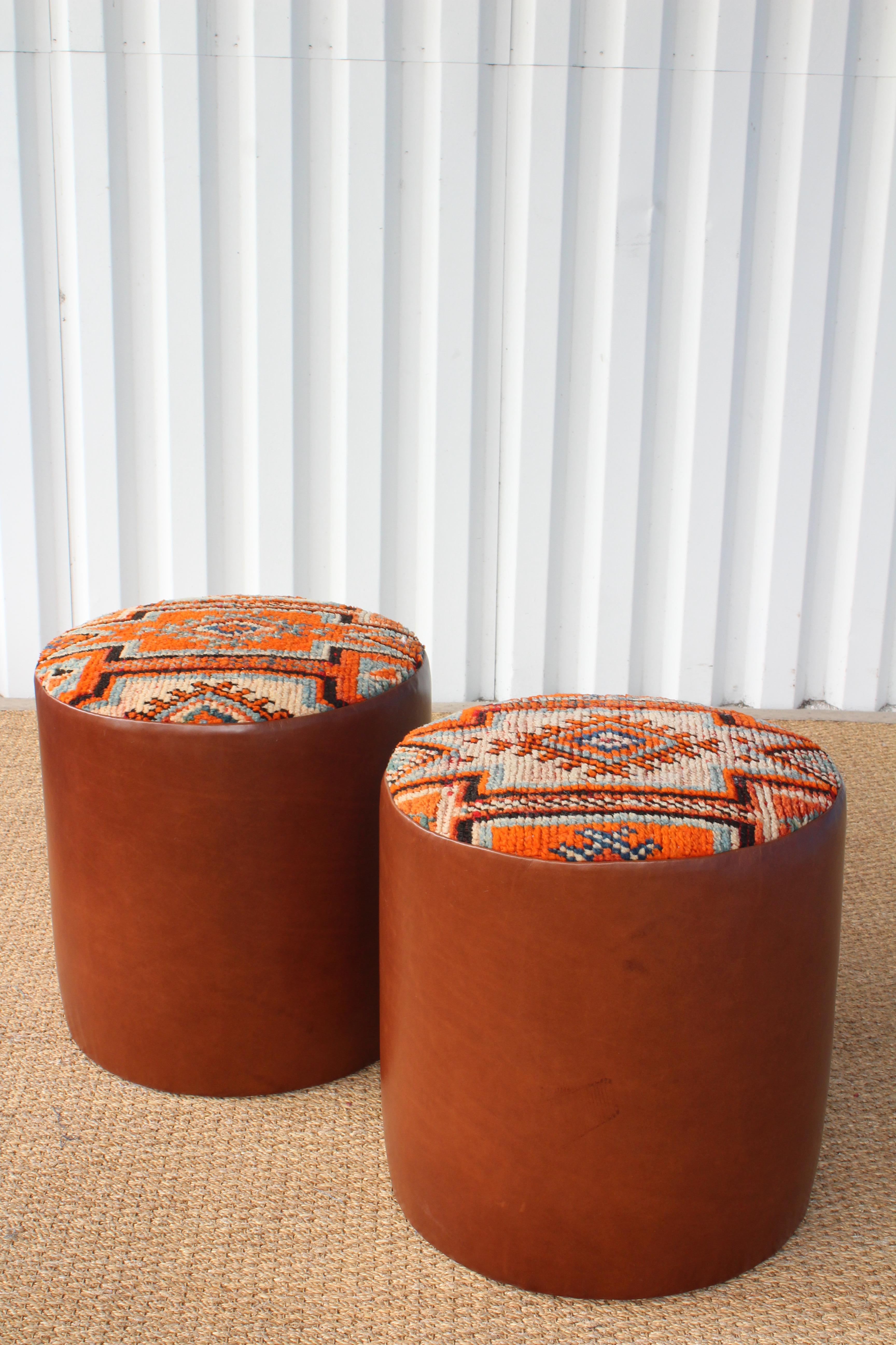 Pair of custom made stools or ottomans with genuine leather boxing and upholstered seats in a vintage wool Moroccan rug from the 1960s. Sold as a pair. In excellent like new condition.