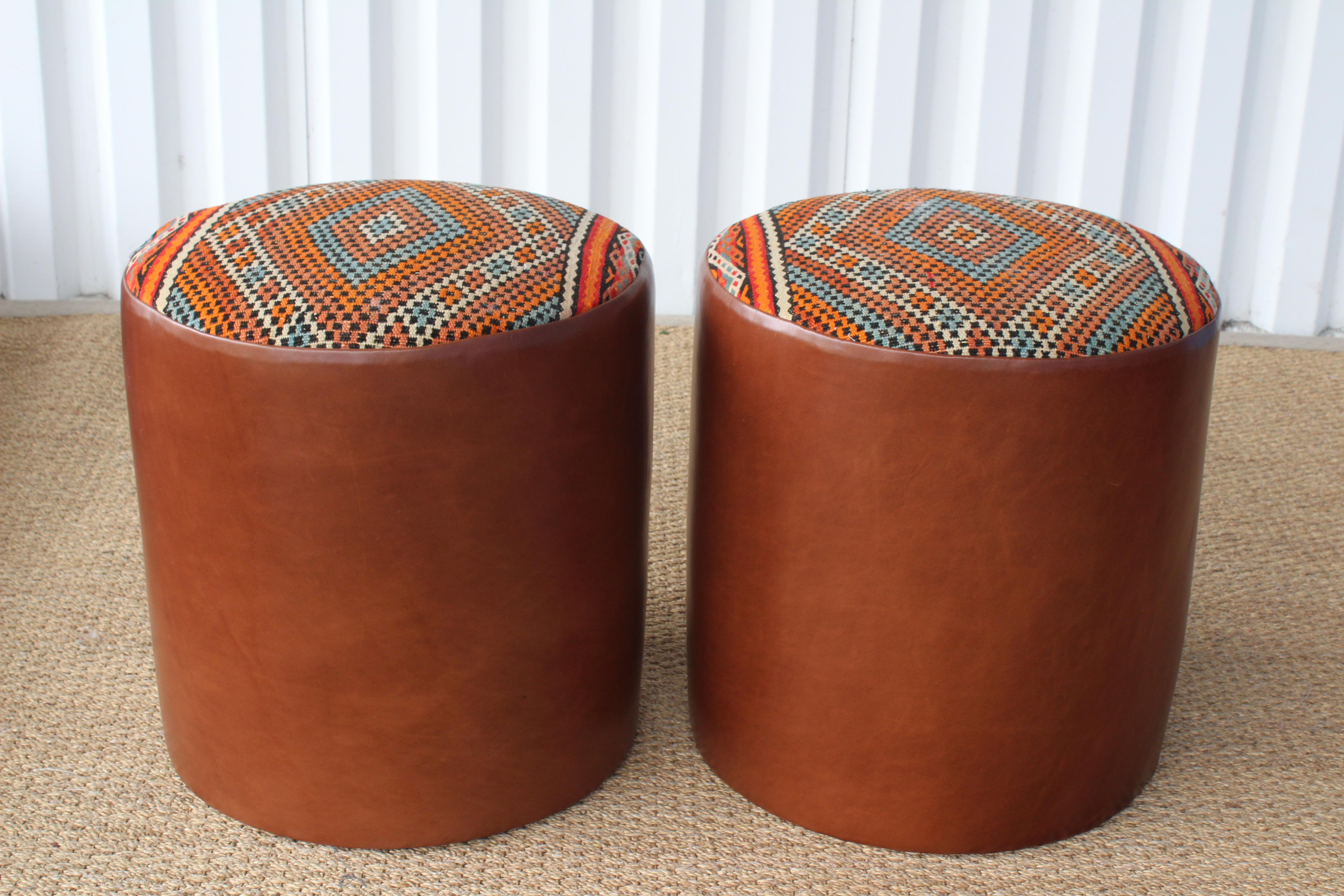 Pair of custom made stools or ottomans with genuine leather boxing and upholstered seats in a vintage wool Moroccan rug from the 1960s. Sold as a pair. In excellent like new condition.