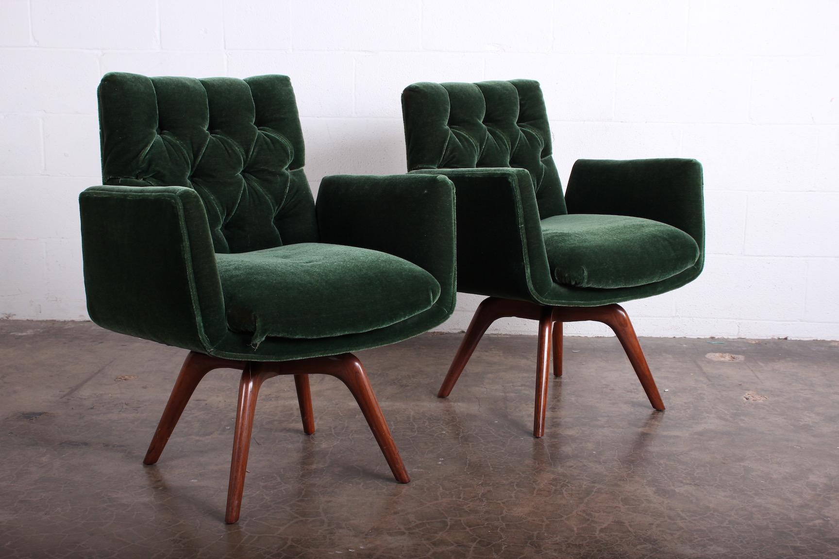 A pair of swiveling armchairs with tufted mohair on walnut bases designed for a Park Ave apartment full of furnishings by Vladimir Kagan. Two pair available.