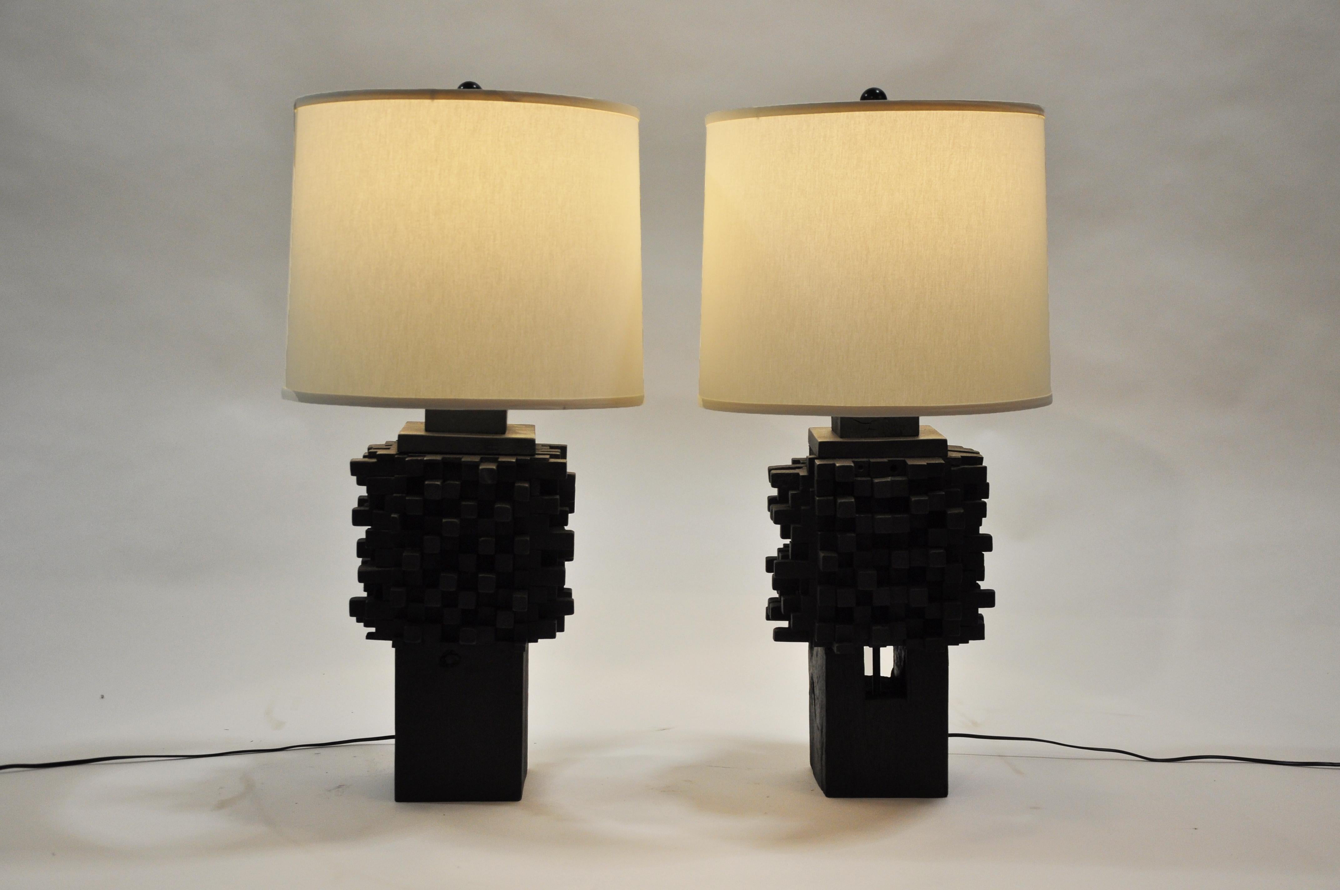 These textured towers are comprised of small blocks of varying sizes constructed in layers upon layers, which create the central pillar-like column. Though solidly built, the stacked fashion gives the illusion of a delicate balancing act.