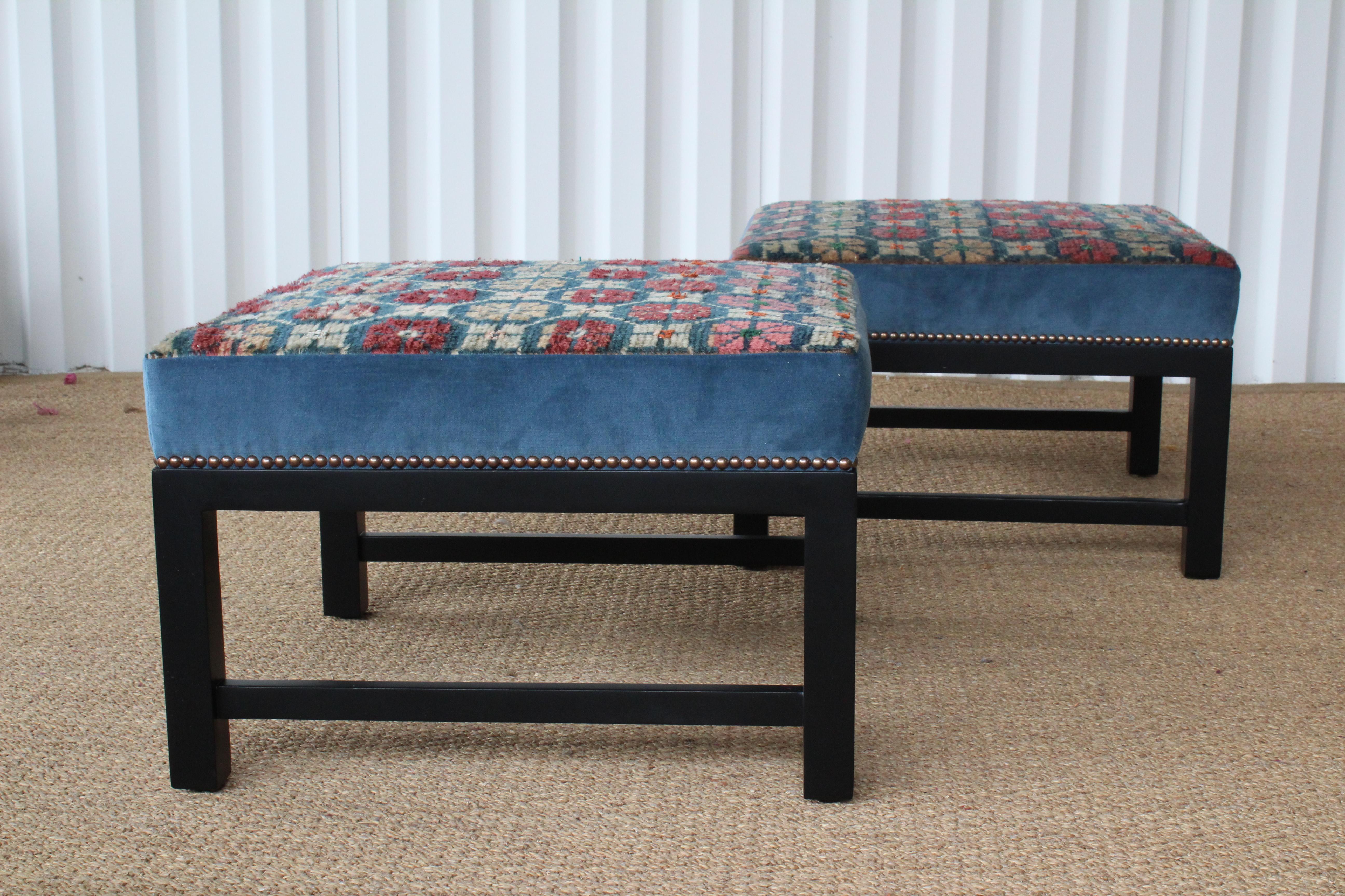Pair of custom made stools. Upholstered with a vintage wool Tibetan rug and blue velvet. Bases are ebonized walnut. Antique brass nailhead details. Sold as a pair.