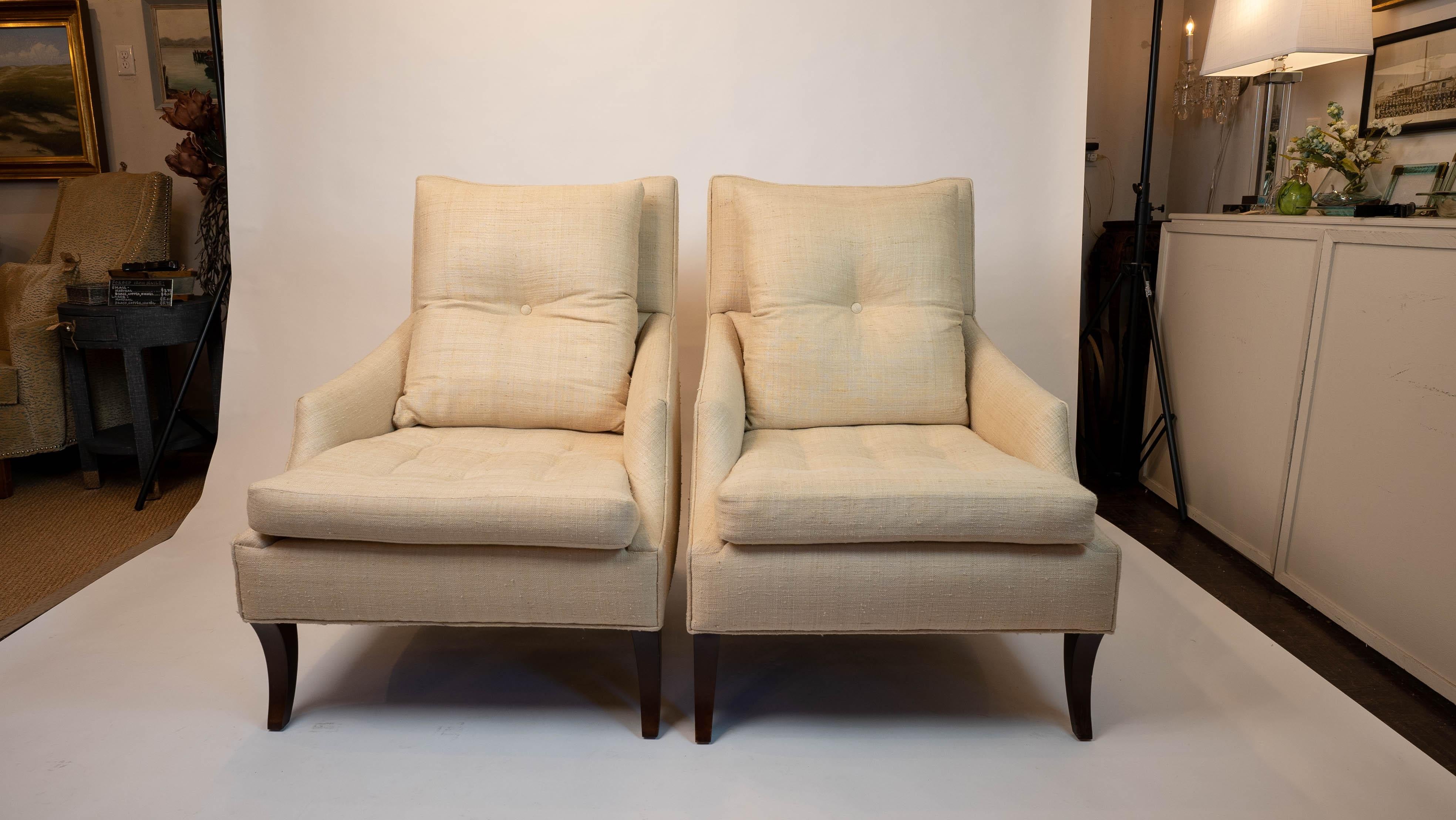 Pair of top-quality, high-end, custom made club chairs with sleek design and curves. Nice tufting details on seat and back cushions, as well as a special tufted button detail on each chair’s back. Seat and back cushions are each unattached, and