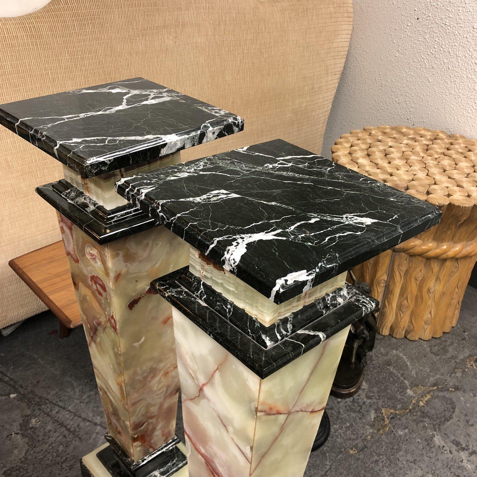 A pair of marble pedestals. Just Stunning! These two-toned marble beauties are a must have. Narrow and tall with tapered square shape. Each pedestal has three pieces that sits comfortably on each other to form this elegant and striking design. One