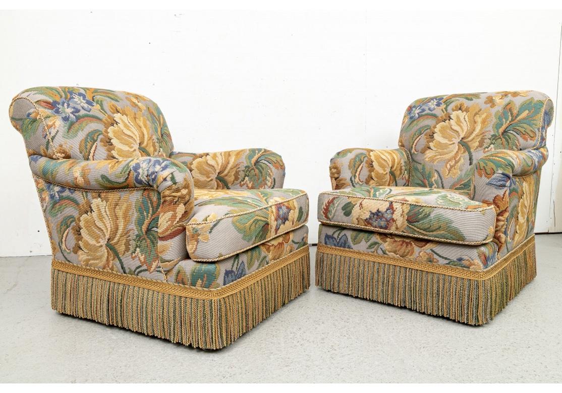 A particularly fine pair of custom Club Chairs by Edward Ferrell. Large comfortable club chairs with rolled crest rails and arms, swivel bases. Upholstered in a fine machine made tapestry fabric in a Floral pattern in soft tones with coordinating