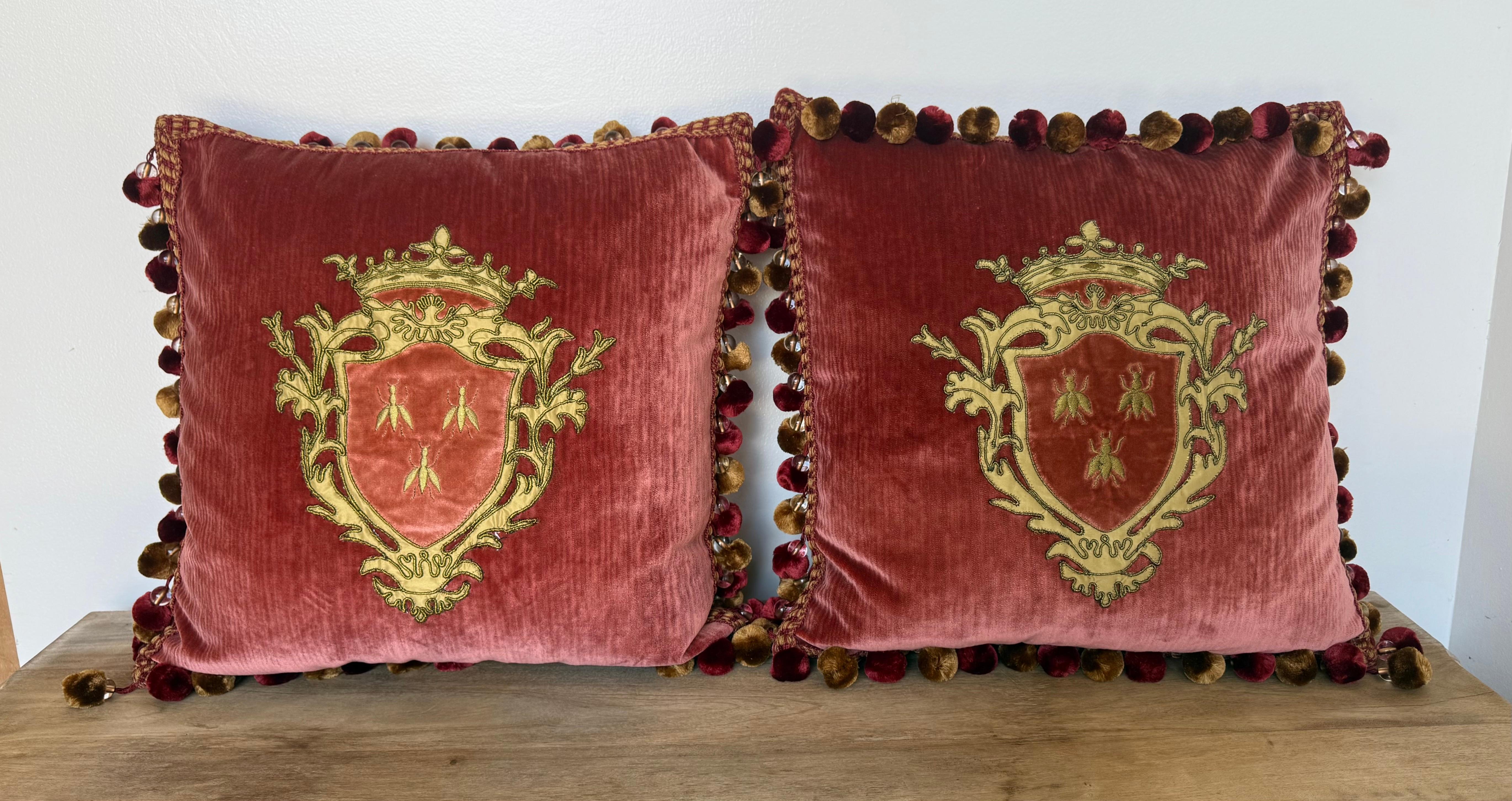 A luxurious pair of custom pillows designed by Los Angeles-based designer, Melissa Levinson, combining antique textiles with contemporary craftsmanship. Each pillow features a vintage embroidered heraldic crest appliqué, rendered in rich gold