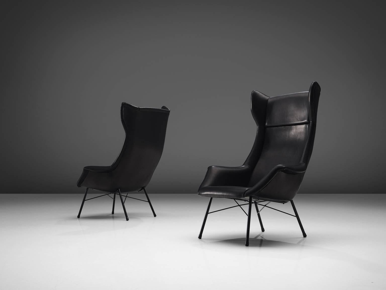 Pair of lounge chairs, black leather and metal, Czech Republic, 1950s. 

Modern set of two high back lounge chairs in black leather and with a metal frame. This fantastic pair of wingback lounge chairs were designed Miroslav Navratil and produced in