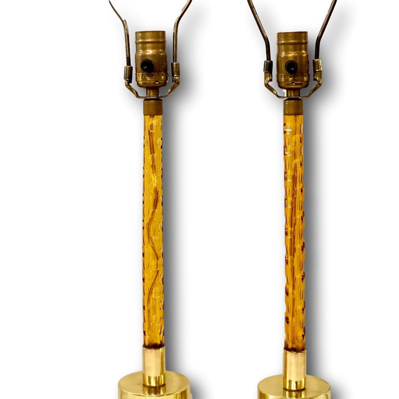 A pair of circa 1940s French amber tone cut-glass stem lamps with bronze bases. 

Measurements:
Height of body 16
