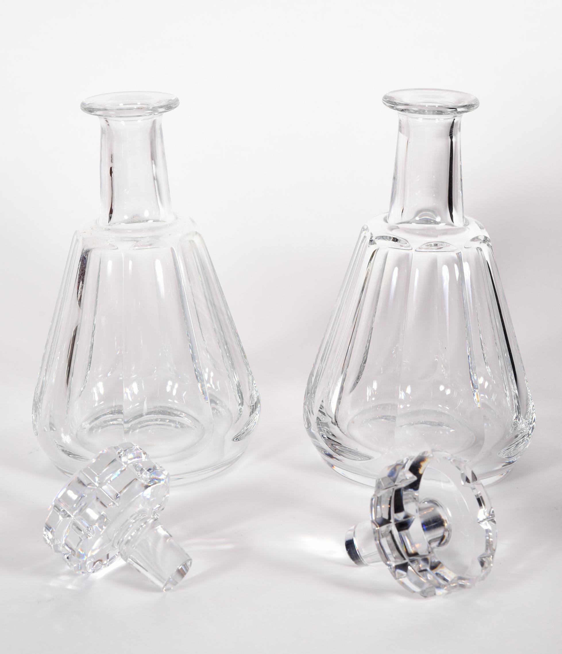 Pair of cut crystal drinks baccarat decanters. These are French mouth blown with hand panel cutting, maker's mark undersigned on each one. The glass is in excellent vintage condition with no breaks or repairs. Each decanter measure about 9.5 inches