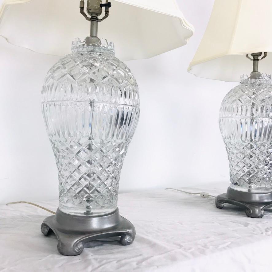 Fabulous pair of 1960s Hollywood Regency style cut crystal table lamps. Metal bases with nickel coating. Shades included.