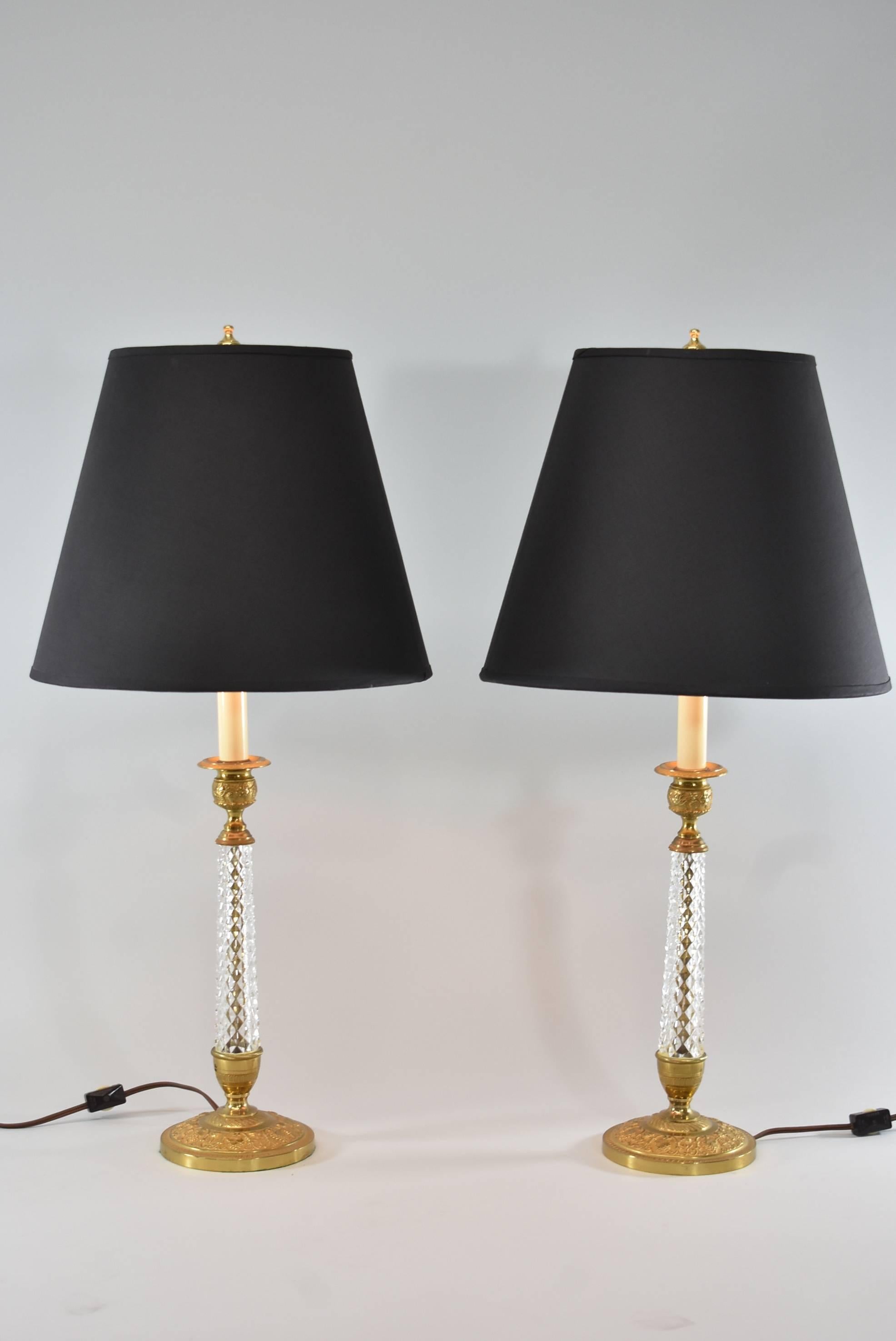 A stunning pair of boudoir lamps. They feature a gold doré finish with grapes and vines and beautiful cut-glass in a candlestick form. They each have a single socket. The shades are not included.