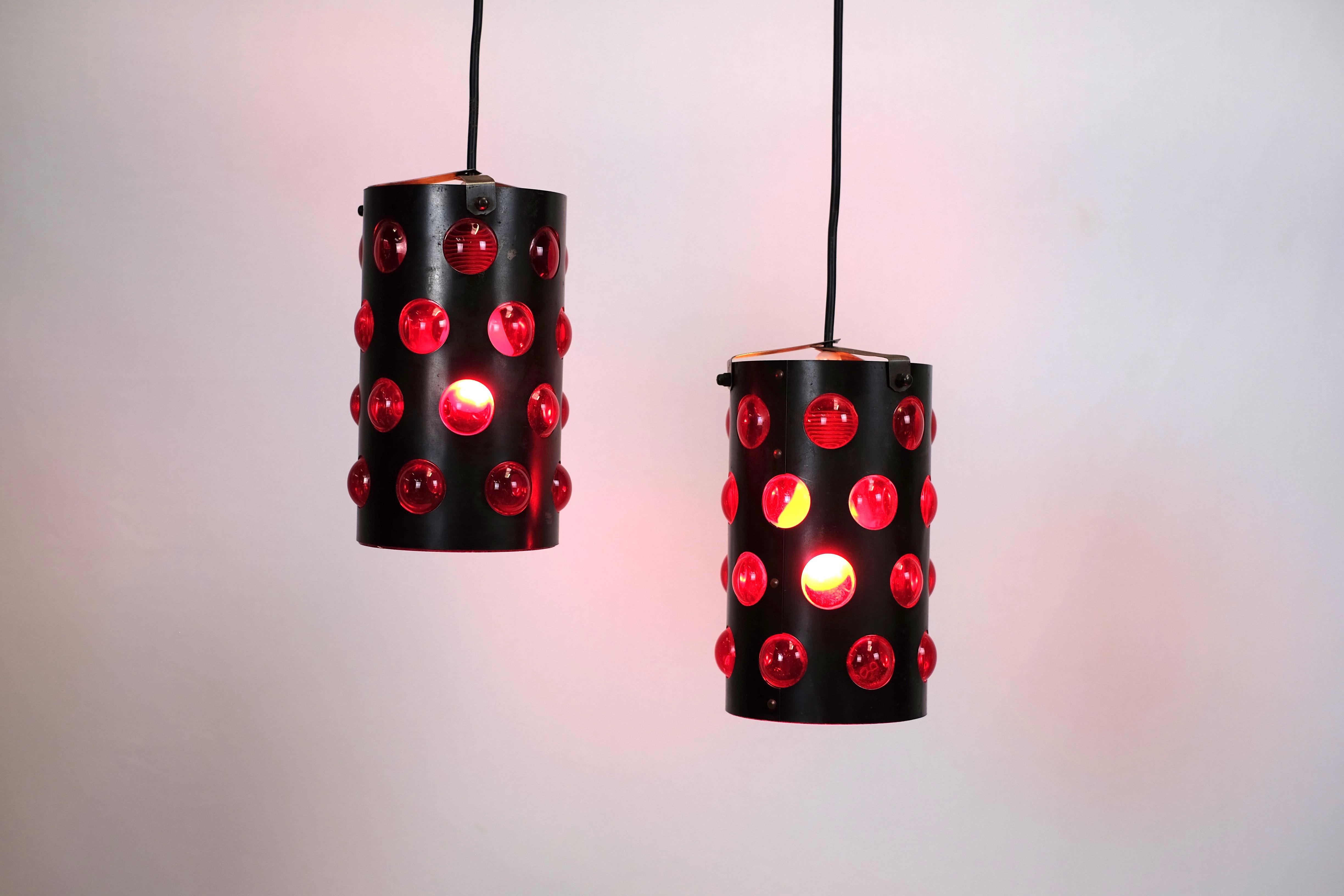 A pair of fun and charming lamps in the very best retro style.
Cylinder shaped lamp with bubbles of red plastic that provides a cozy light.
Danish design, but I haven't been able to find the designer. They are both in good vintage condition.
 