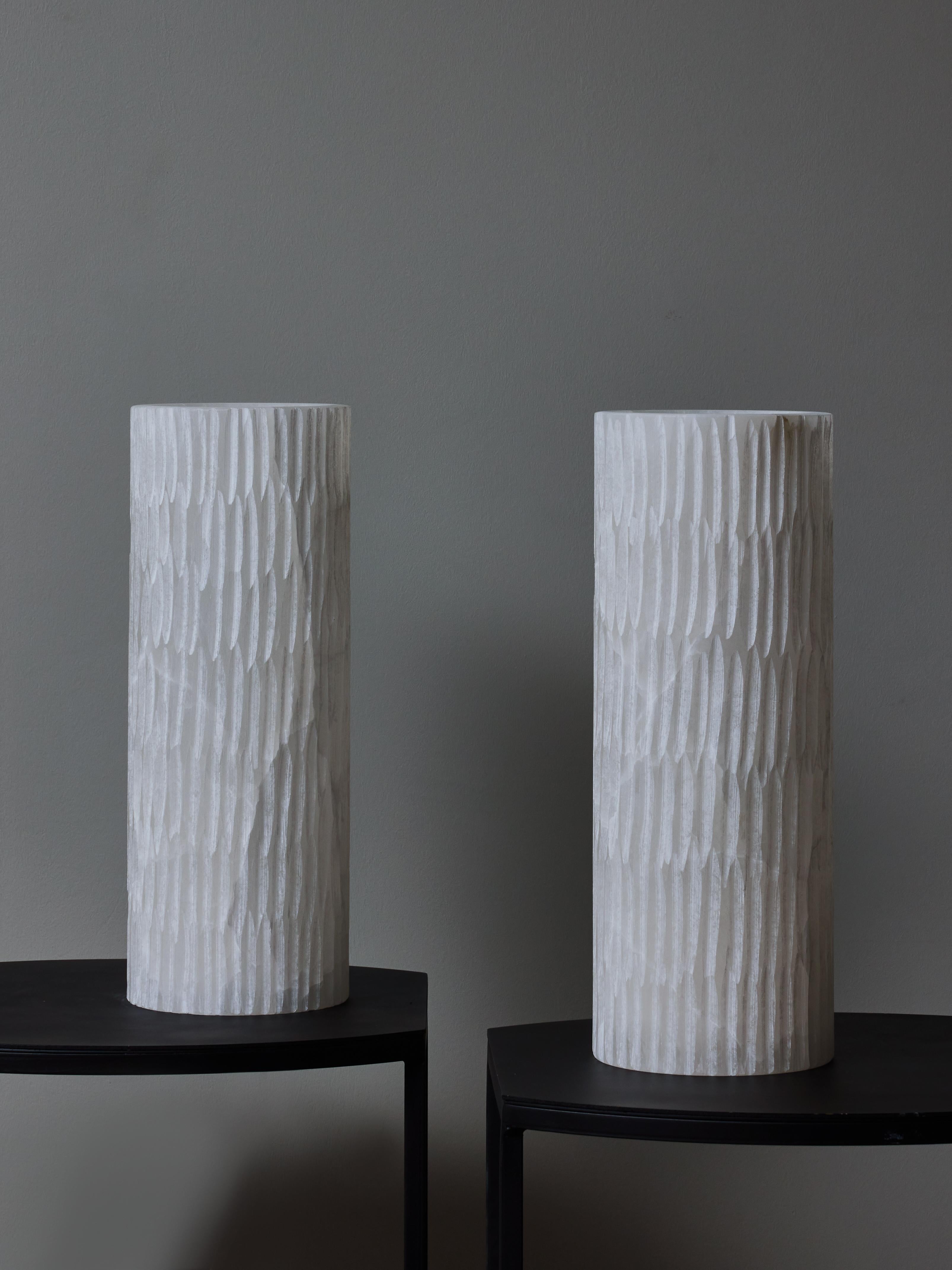 Pair of table lamps made of a single cylindrical piece of alabaster with notch decors all over.