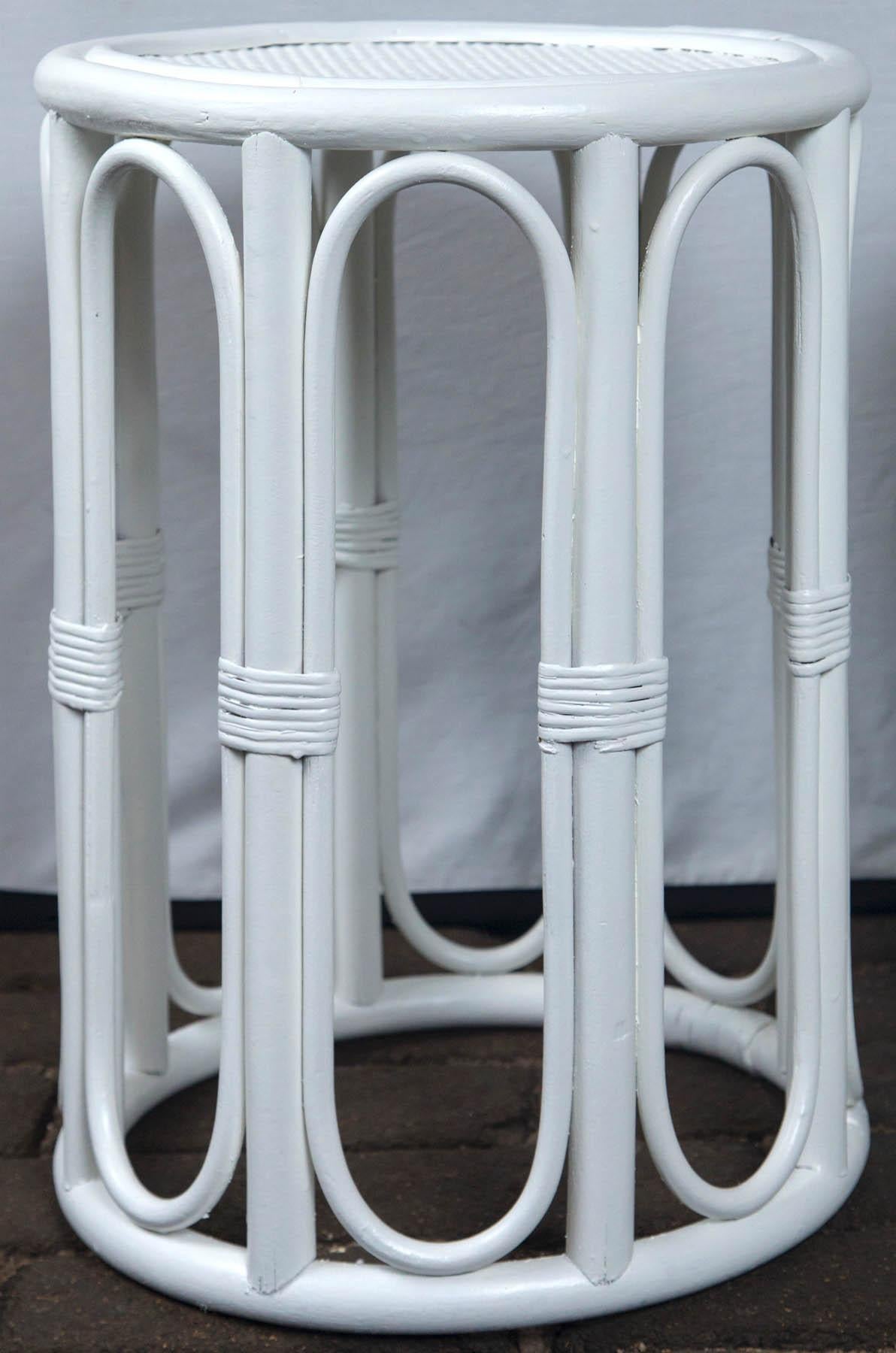 Pair cylindrical white painted rattan side tables.