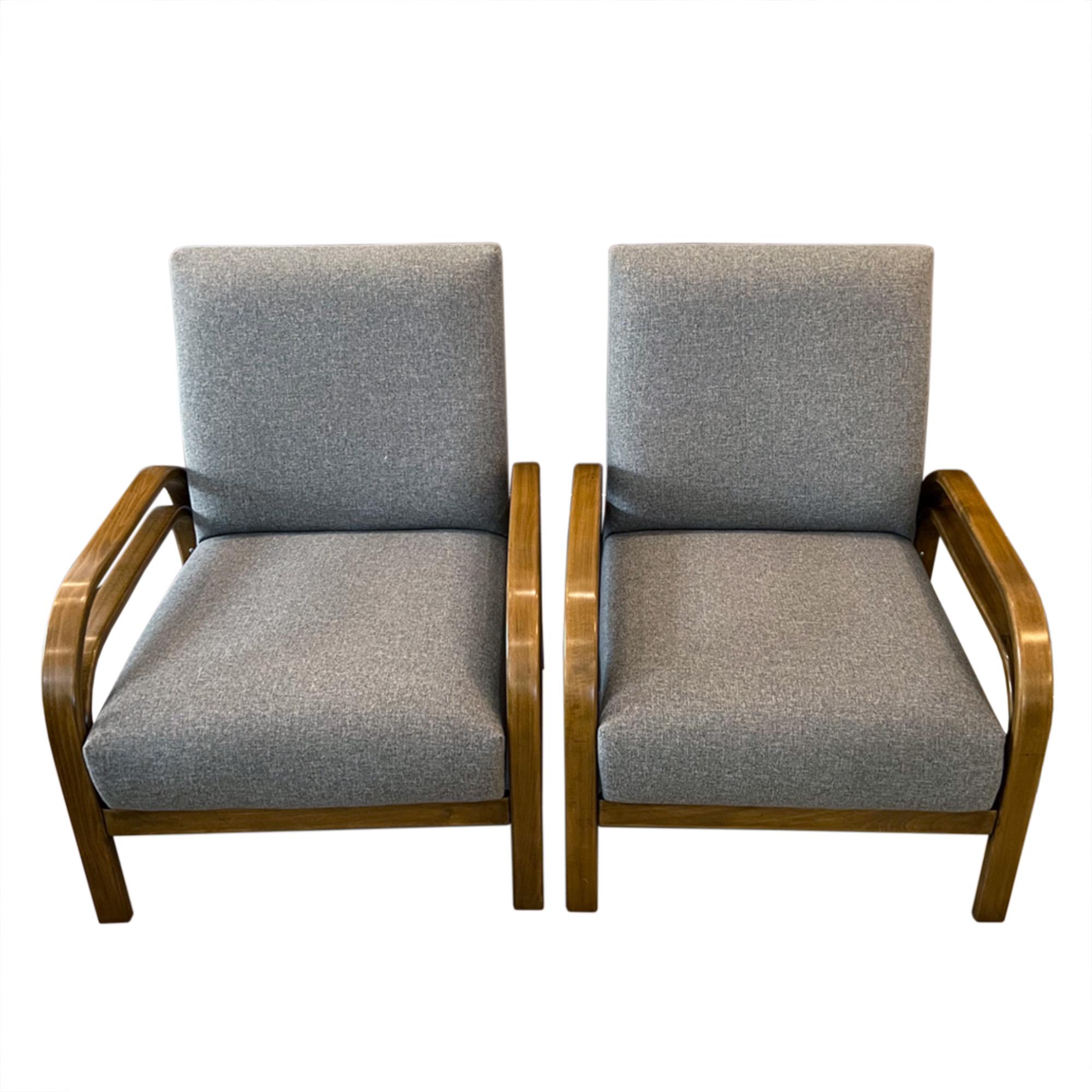 A really stylish, comfortable pair of mid century chairs, reupholstered in luxurious wool fabric.

These chairs were crafted in what was then Czechoslovakia in the 1950s, the bent wood creates elegant deco lines on the arms. 

Seat height is