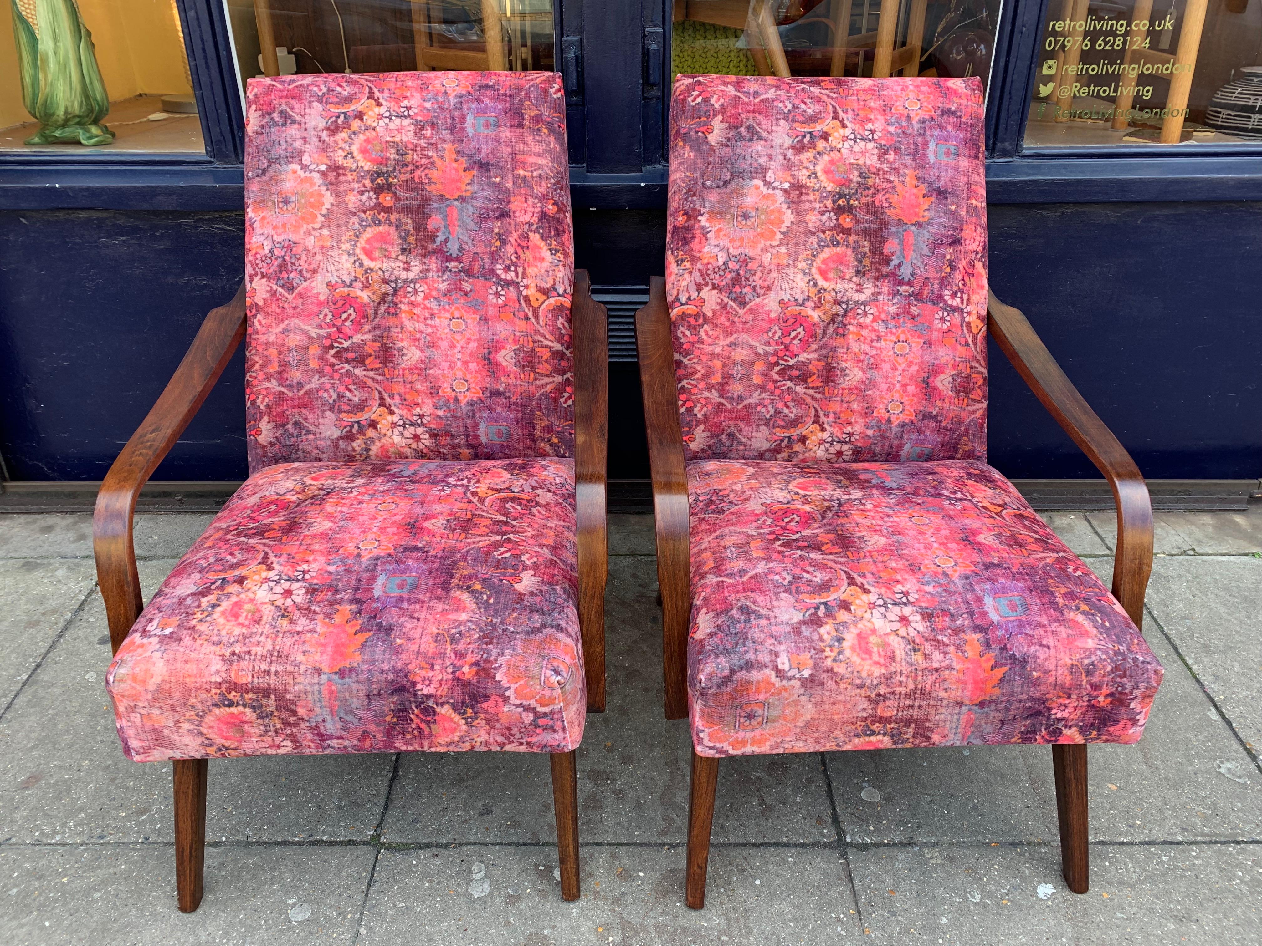 1960s pair of Czech armchairs. The frames are in a dark stained beech which contrasts beautifully with the contrasting and similar colors in the fabric. The chairs have been fully restored, refinished, polished and reupholstered in Linwood