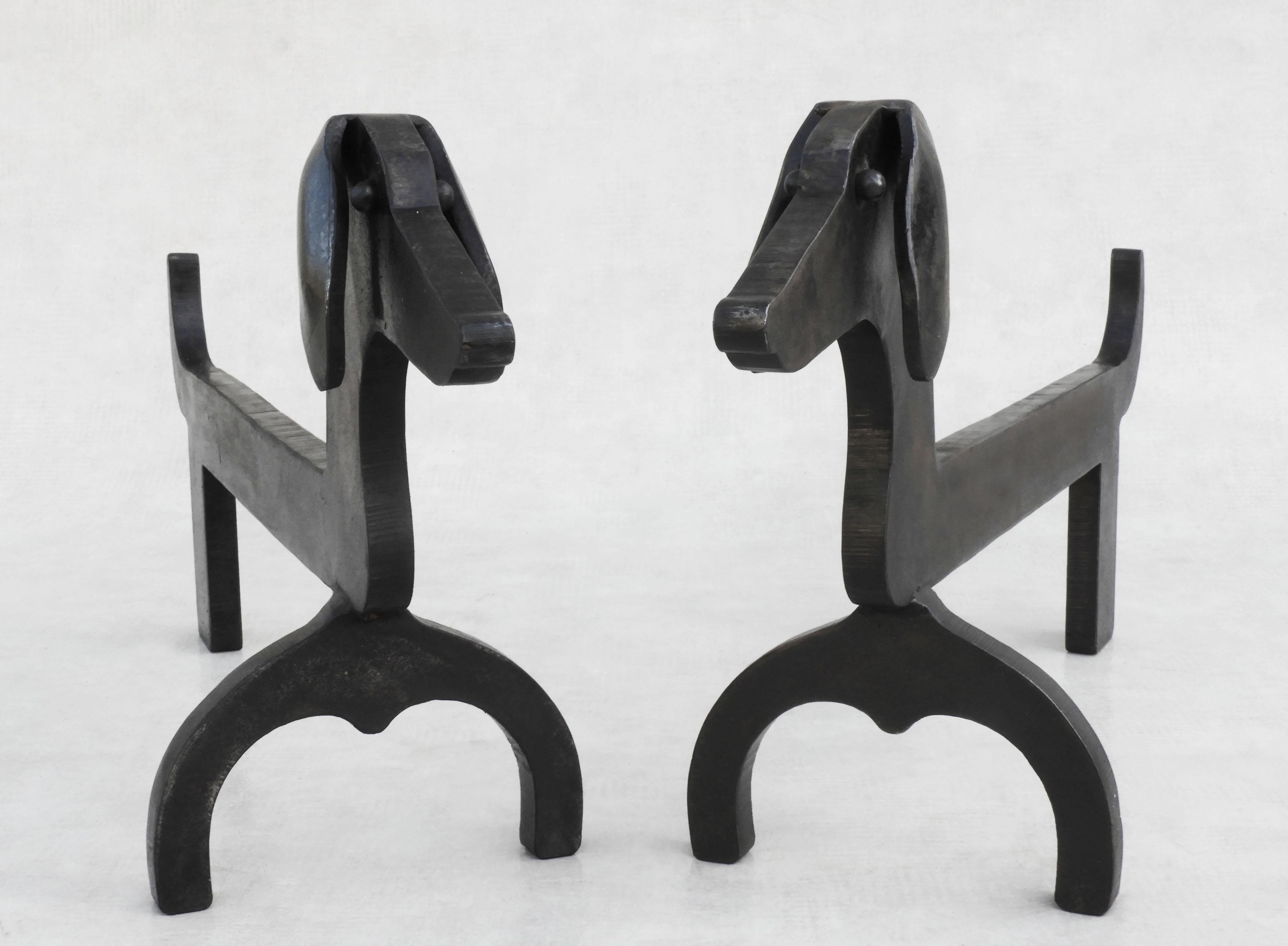 Great pair of Dachshund andirons in the style of Edouard Schenck.

A charming duo of Iron 'fire dogs' in very good vintage condition with great patina.

Dimensions:  H29cm/11.41in L59cm/23.22in D16.5cm/6.5in W6kg/13.22lbs each

Priced per pair.