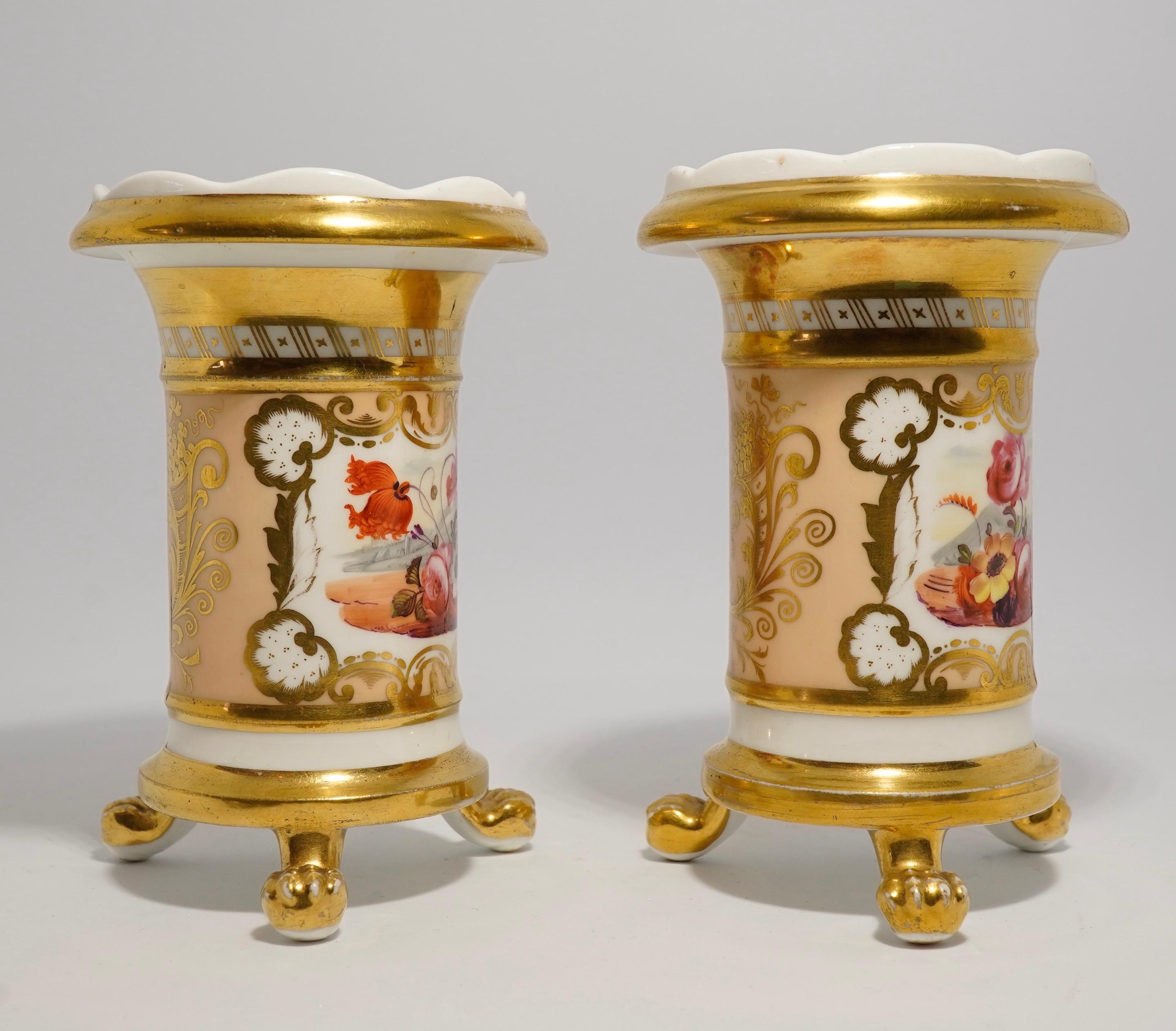 Pair of Daniel porcelain spill vases, with flared and lobed rims and standing on three protruding lions-paw feet, decorated with rich gilding and enameled flower panels on an apricot ground, within wide gilt bands.
Pattern no. 1127,
circa 1830.