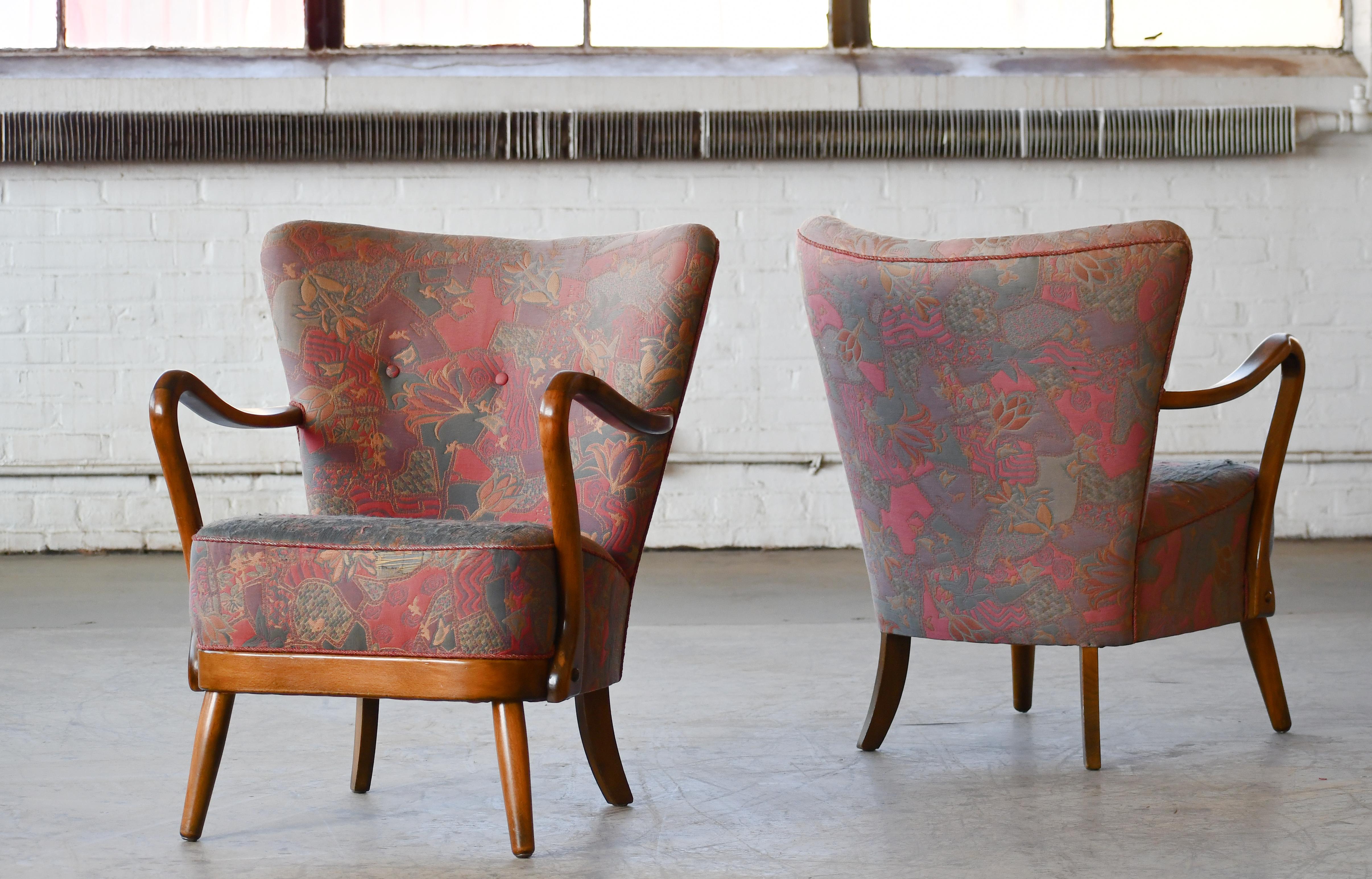 Classic pair of elegant Danish low back armchairs from the 1940s by Alfred Christensen for Slagelse Mobelvaerk with closed armrests in beautifully Cuban mahogany which is a bit unusual for Alfred Christensen as much of his furniture was produced