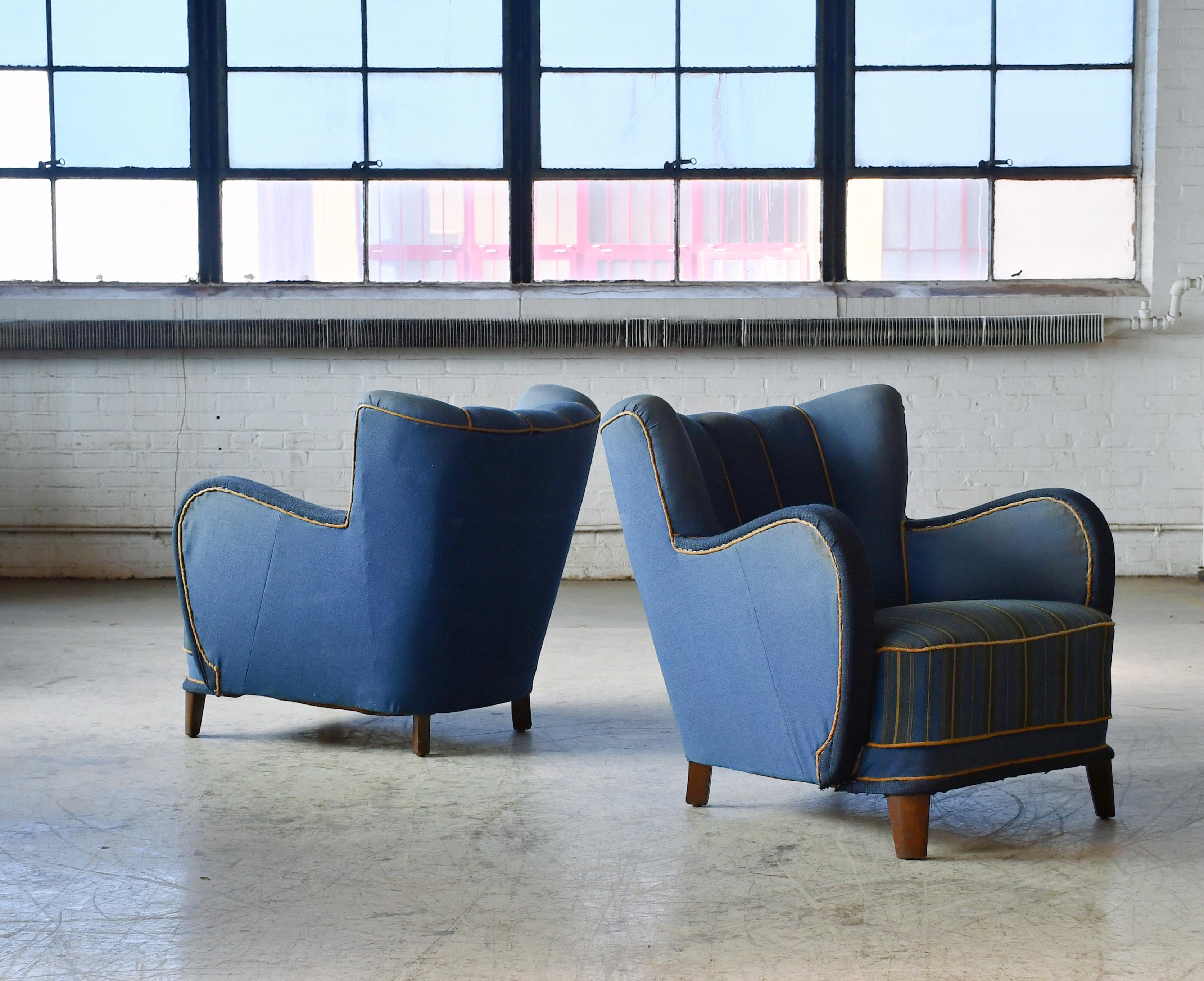 Pair of sublime mid-scale Danish club or lounge chair made in the 1930-40s. The chairs are very similar to Fritz Hansen's famous model 1669 but exhibits a more rounded armrest. We love the low slung voluptuous proportions. These chairs are superbly