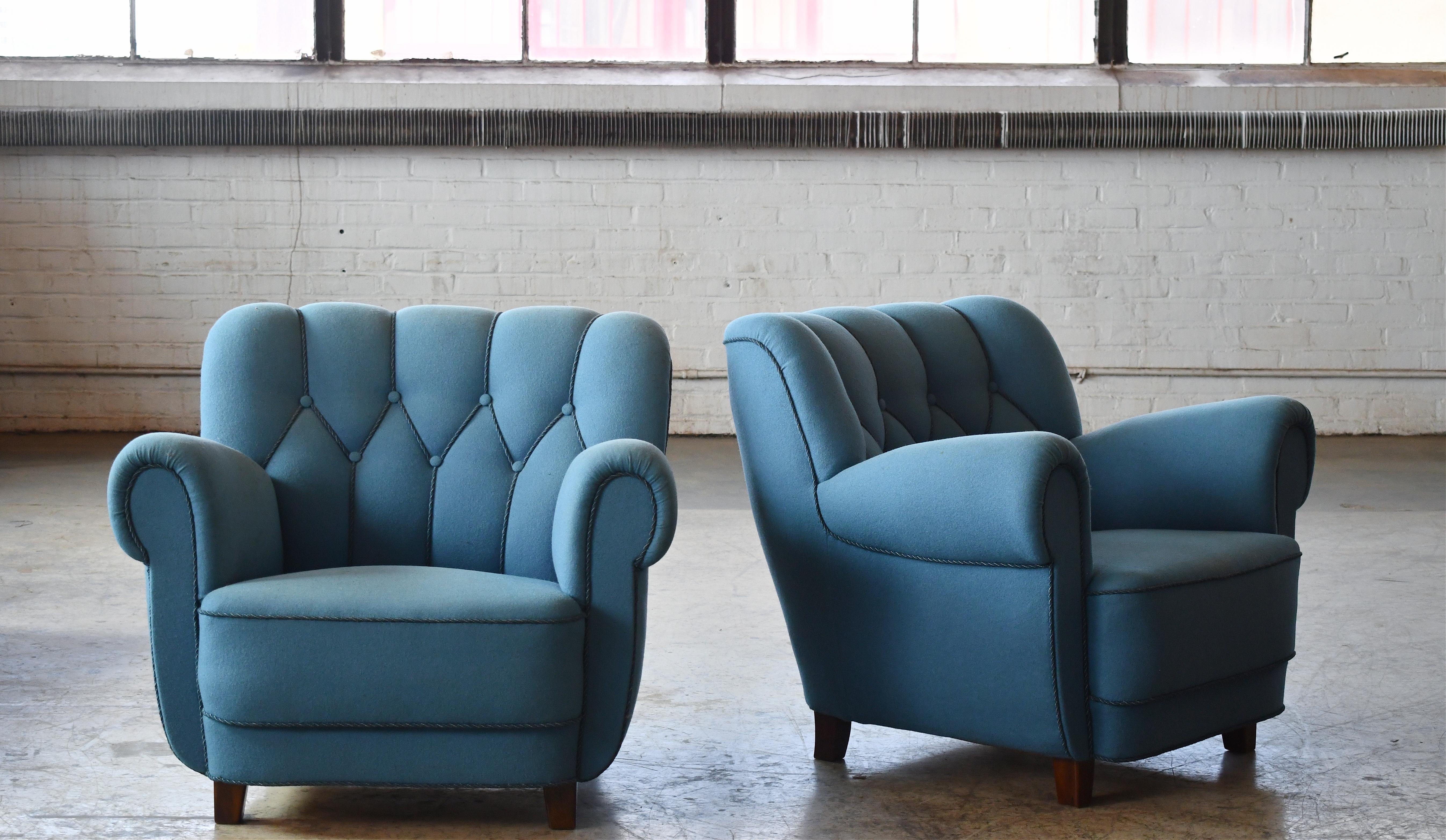 Pair of sublime large Danish club or lounge chair made in the 1940s. These chairs are superbly comfortable with coil springs in seat and backrest with a very strong presence to anchor any room. We love the low and wide proportions. They have been