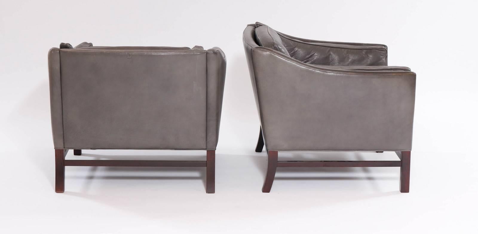 Pair of Danish 1960s club chairs of square form by Grandt. The chairs upholstered in grey leather.