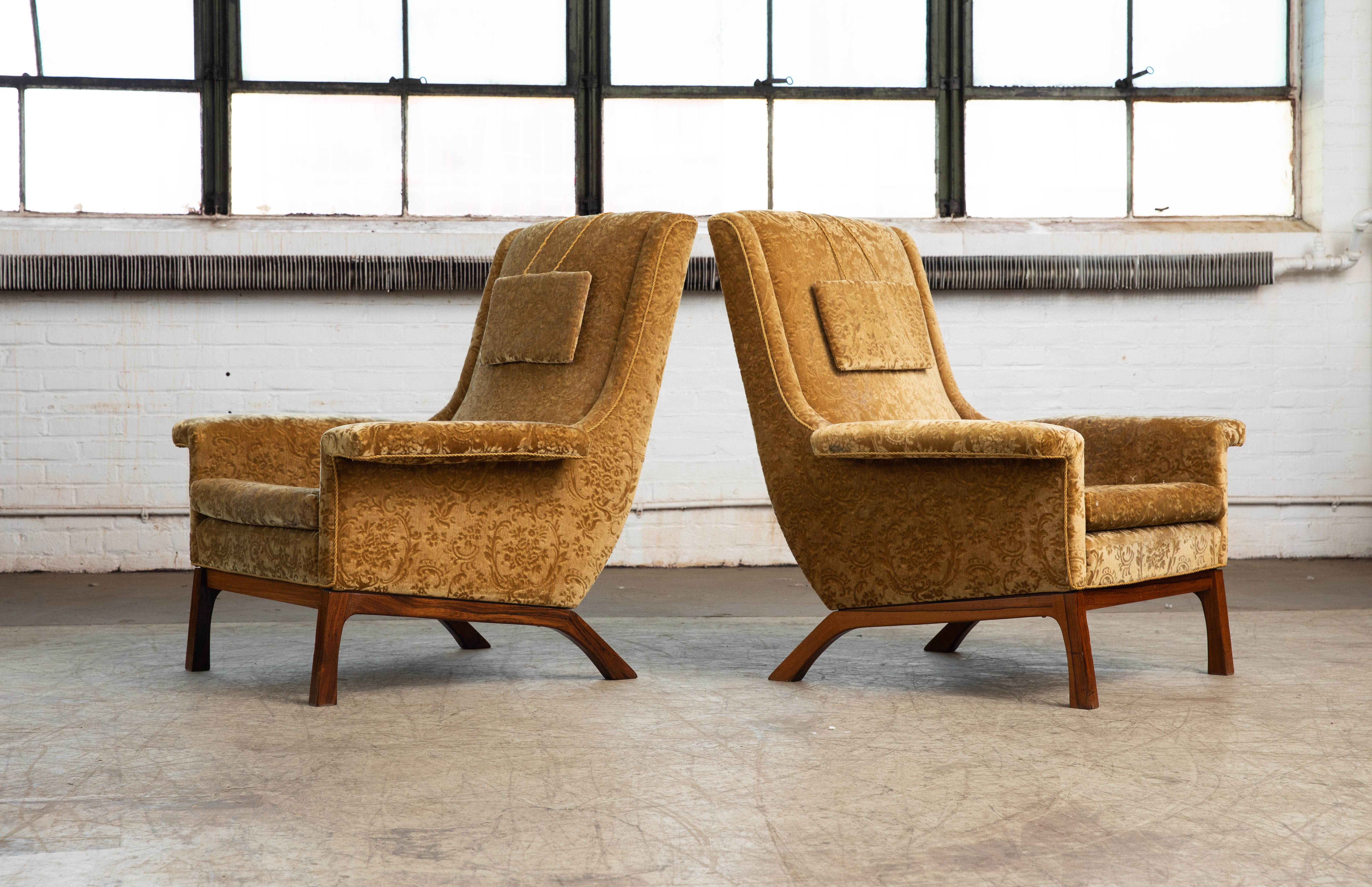 Classic and very elegant pair of lounge chairs in the style made famous by Folke Ohlsson in the mid 1950's for Fritz Hansen and DUX of Sweden. Probably made around 1960 we love the elegant angles of the chairs and the legs combined the slim