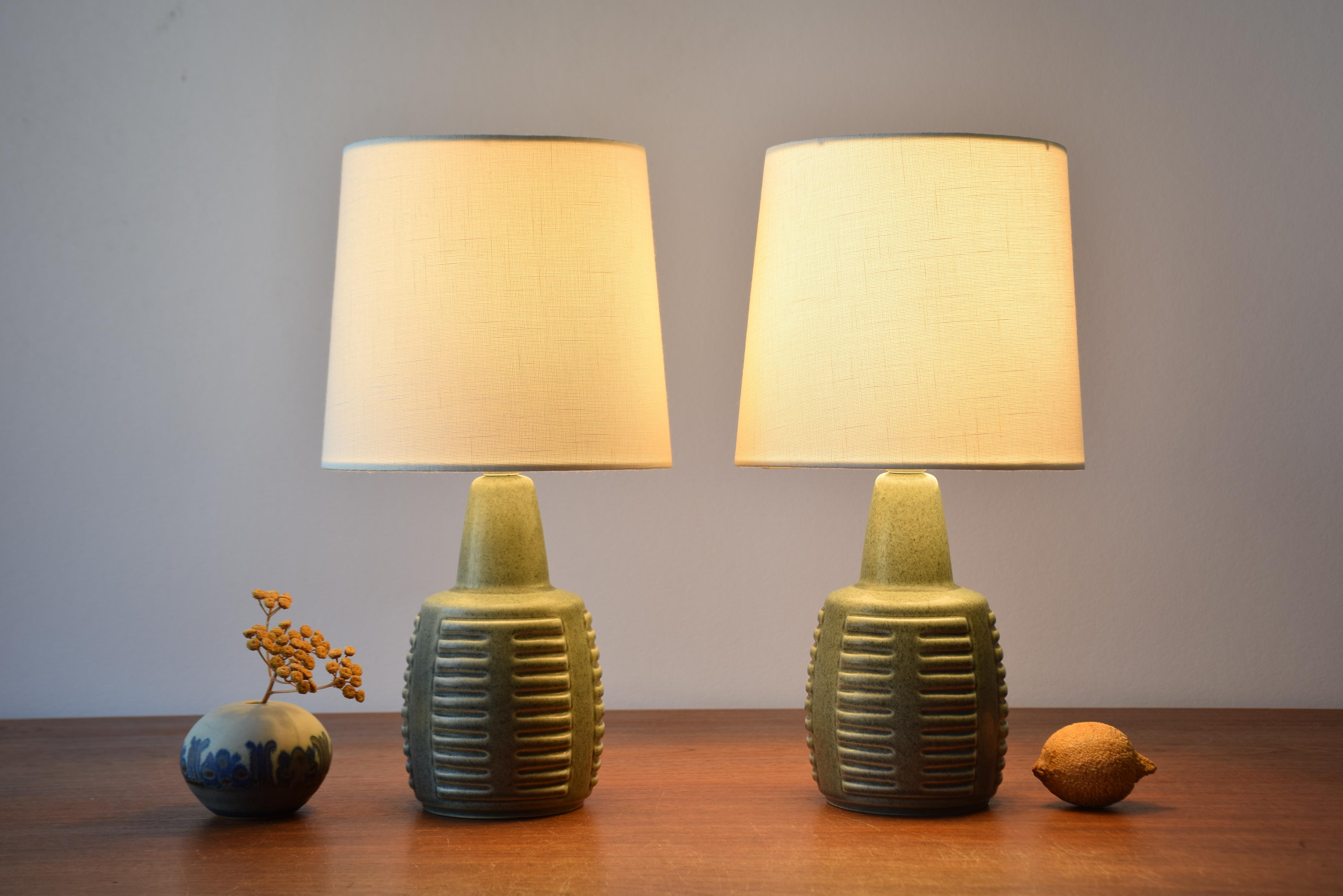 Pair of small table lamps by Einar Johansen for Søholm Stentøj, Denmark, made circa 1960s. They are perfect as bedside lamps
The lamps have dusted green speckled glaze with very little difference in color between the two lamps.

Included are new