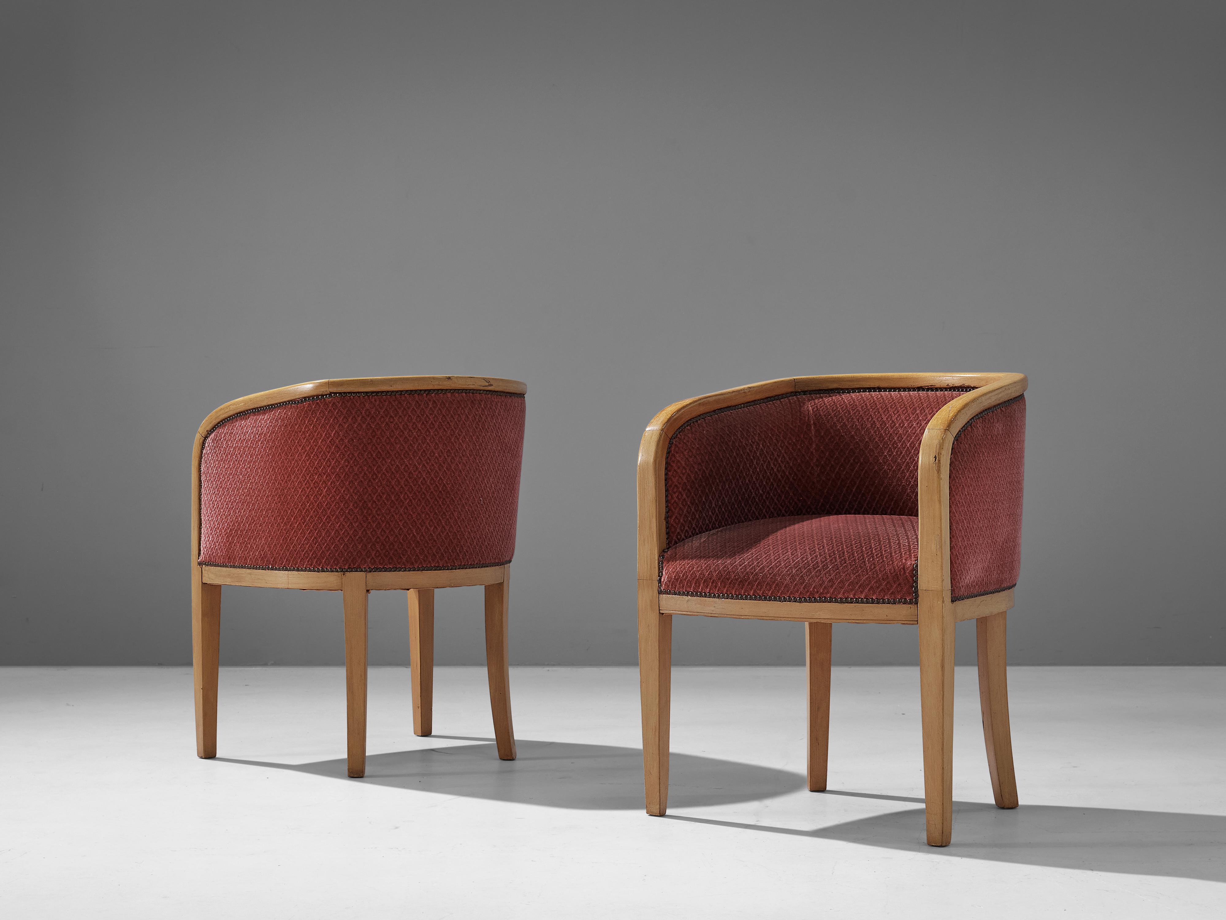 Pair of armchairs, fabric, brass, beech, Denmark, 1950s

A bright frame in beech wood curves around the seat and backrest. Both chairs are upholstered in a soft pink fabric that is attached to the frame with brass nails. From the back, the chair is