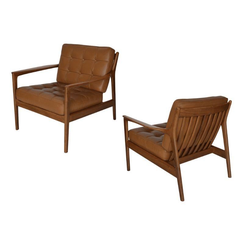 Pair of Danish armchairs with leather upholstery.