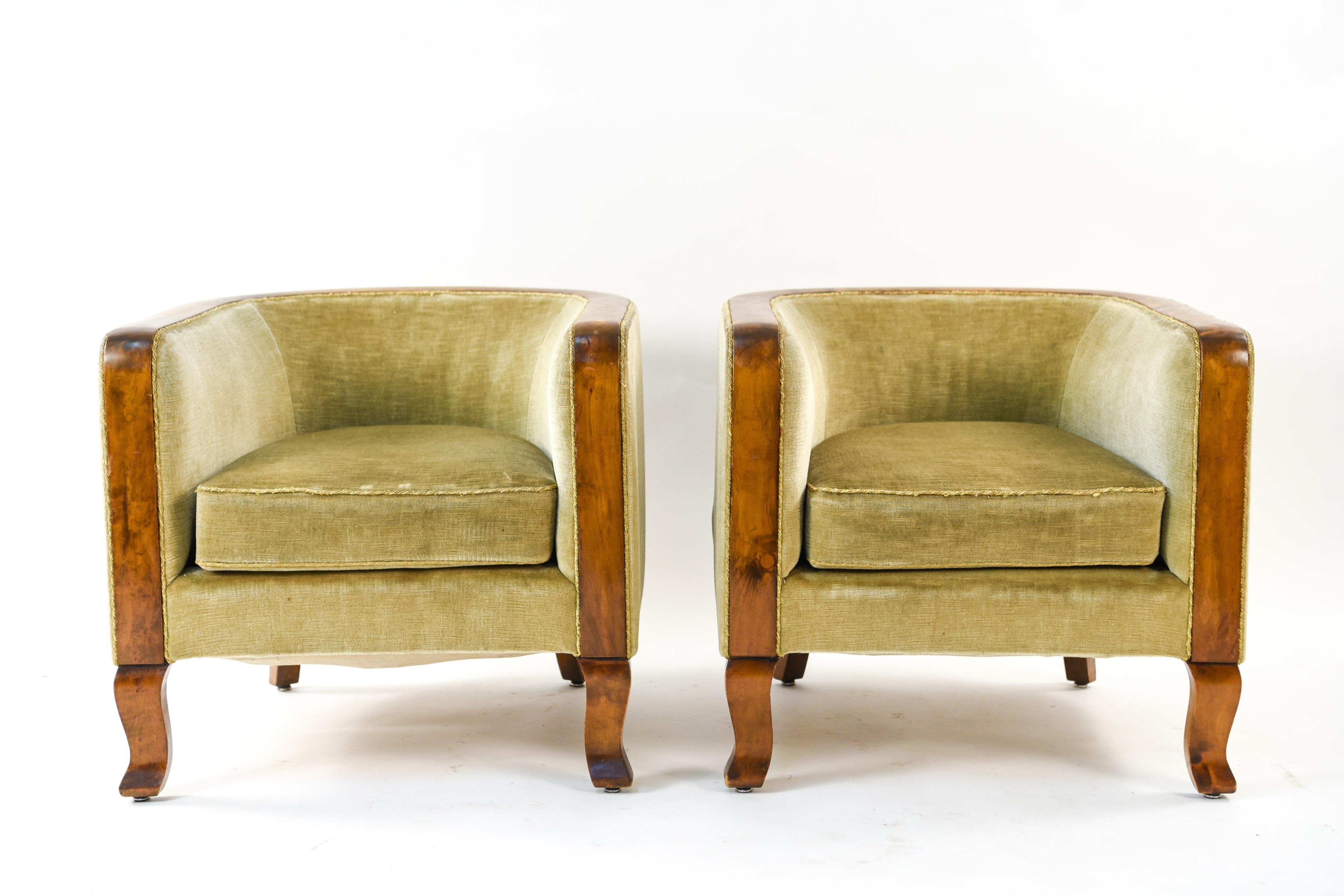 This pair of Danish Art Deco club chairs date to the 1940s and feature a lovely wood trim around the sides and back. A great example of the Art Deco style that retains its timeless desirability.