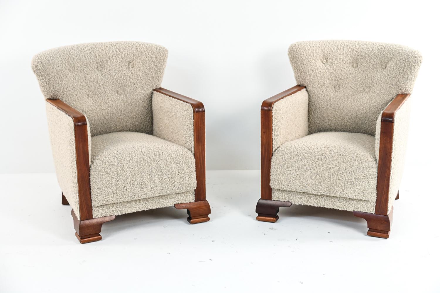 A fabulous pair of Danish Art Deco easy chairs with beech wood frames and upholstered in luxurious curly wool boucle with button tufted backs. These 1930's low-back wingback club chairs mark the transition from Deco design into Scandinavian modern