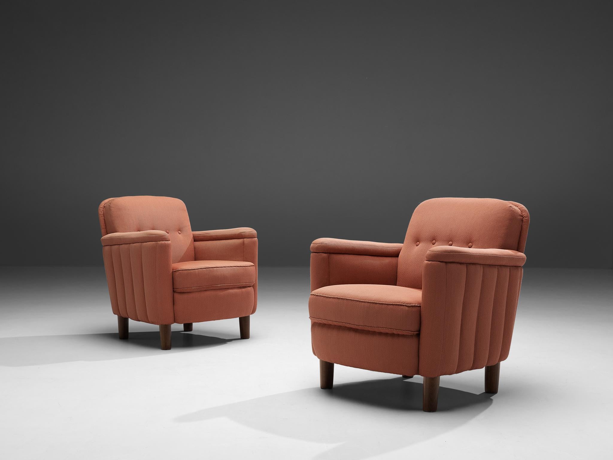 Easy chairs, pink fabric, beech, Denmark, 1930s

Wonderful, comfortable art deco chairs. This armchairs have beautiful details such as the structured sides of the armrest, which adds a gorgeous feature in the overal look. The nice, dark color of the
