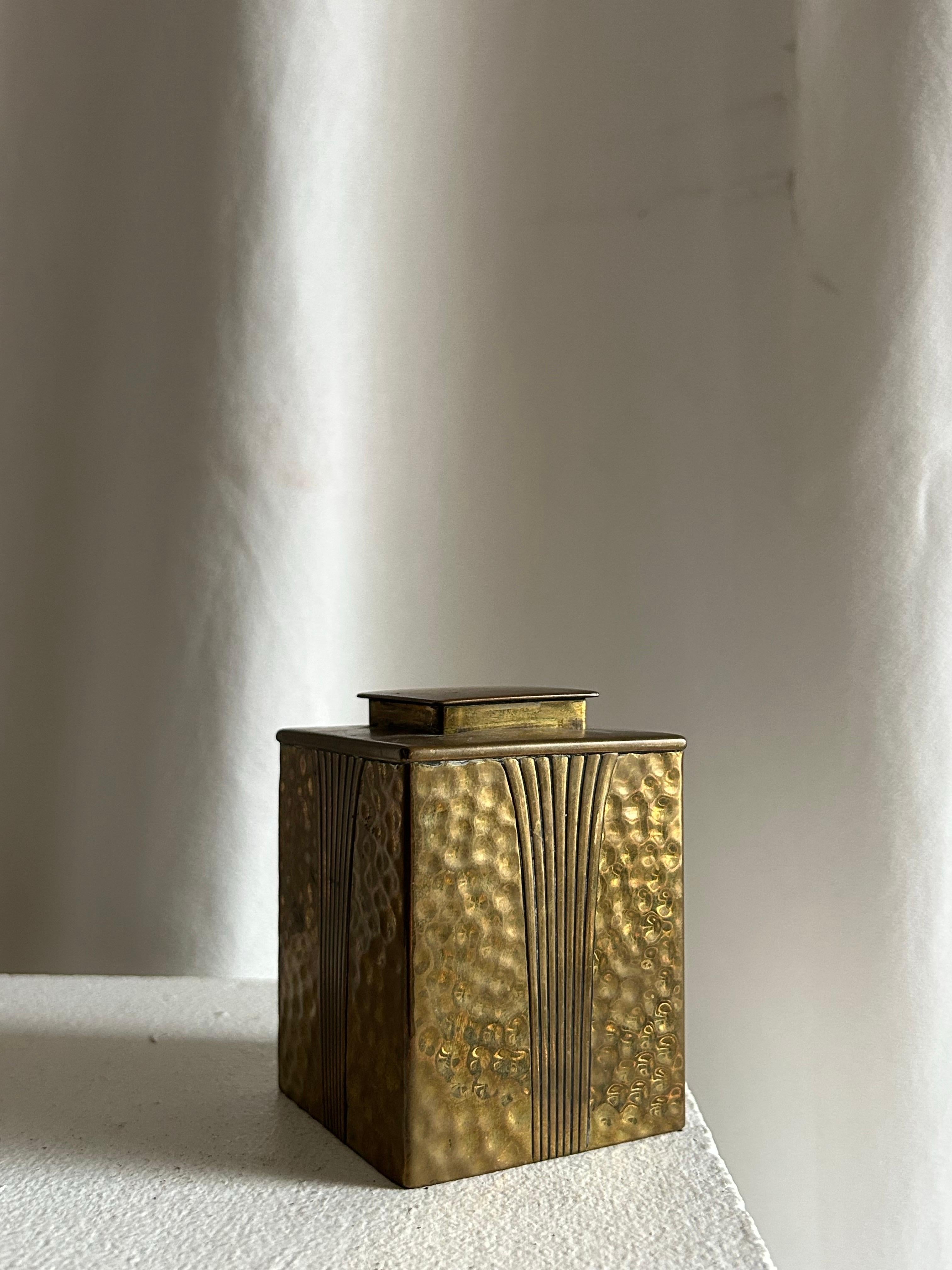 Rare pair of Danish Art Deco lidded boxes, executed in hand-hammered brass with elegant fluted (cannelé) decoration. Each box presents a unique sculptural variation — one with a broad, full-width lid that completely covers the top, the other with a