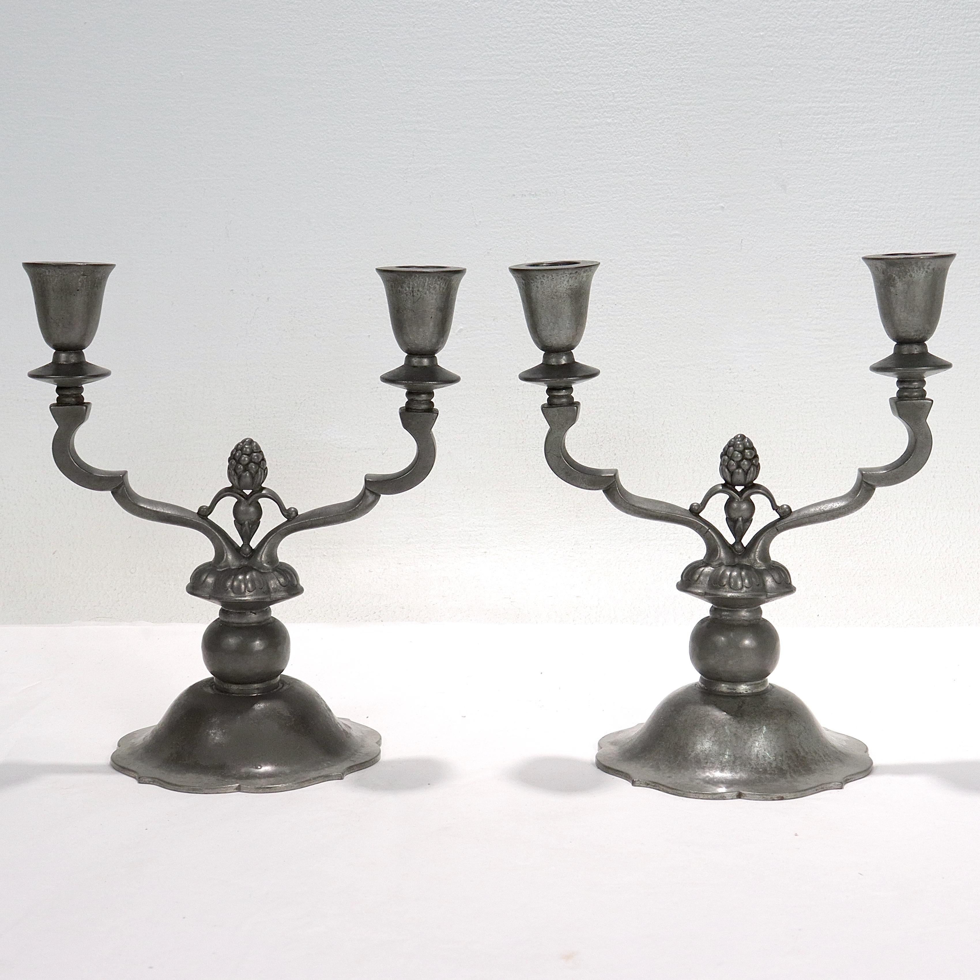 A fine pair of antique pewter candlesticks or candelabra.

By Just Andersen.

Dessin (design) #307.

Each with a beautiful patina throughout.

Marked to the base of each with Denmark /Just Andersen's maker's mark / 1929 / 307.

Simply a great pair
