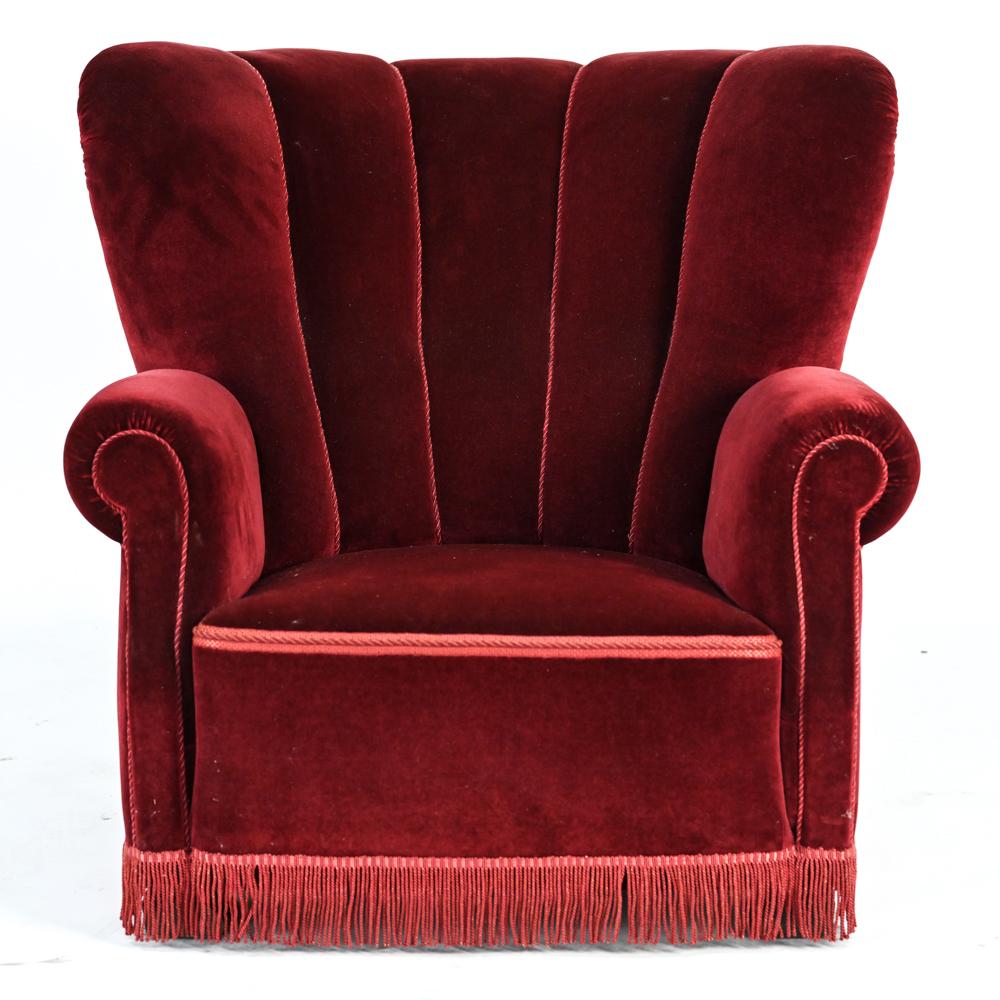 A pair of Danish Art Deco period club or lounge chairs upholstered in luxurious piped red velvet with fringed bottoms, c. 1940's. From the Skovbo Estate in Fyn, Denmark. Danish 1940s Large Club Chairs in the Style of Fritz Hansen Model 1518