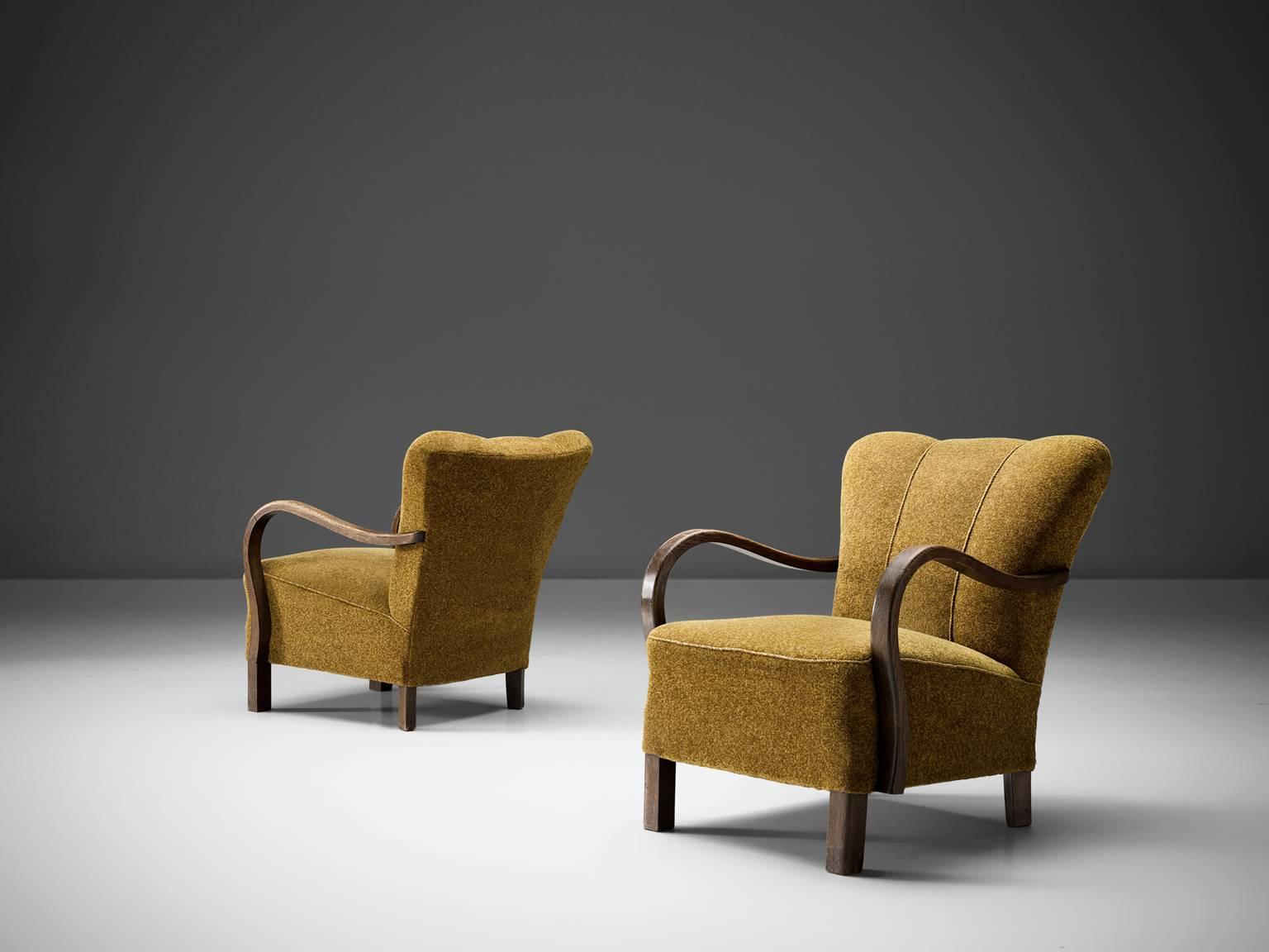 Lounge chairs, ocre yellow upholstery, beech, Denmark, 1940s 

The chairs have semi high wingbacks and feature mustard upholstery with golden vertical stripes on the top and sturdy block like wooden legs. When seen from the front the chairs