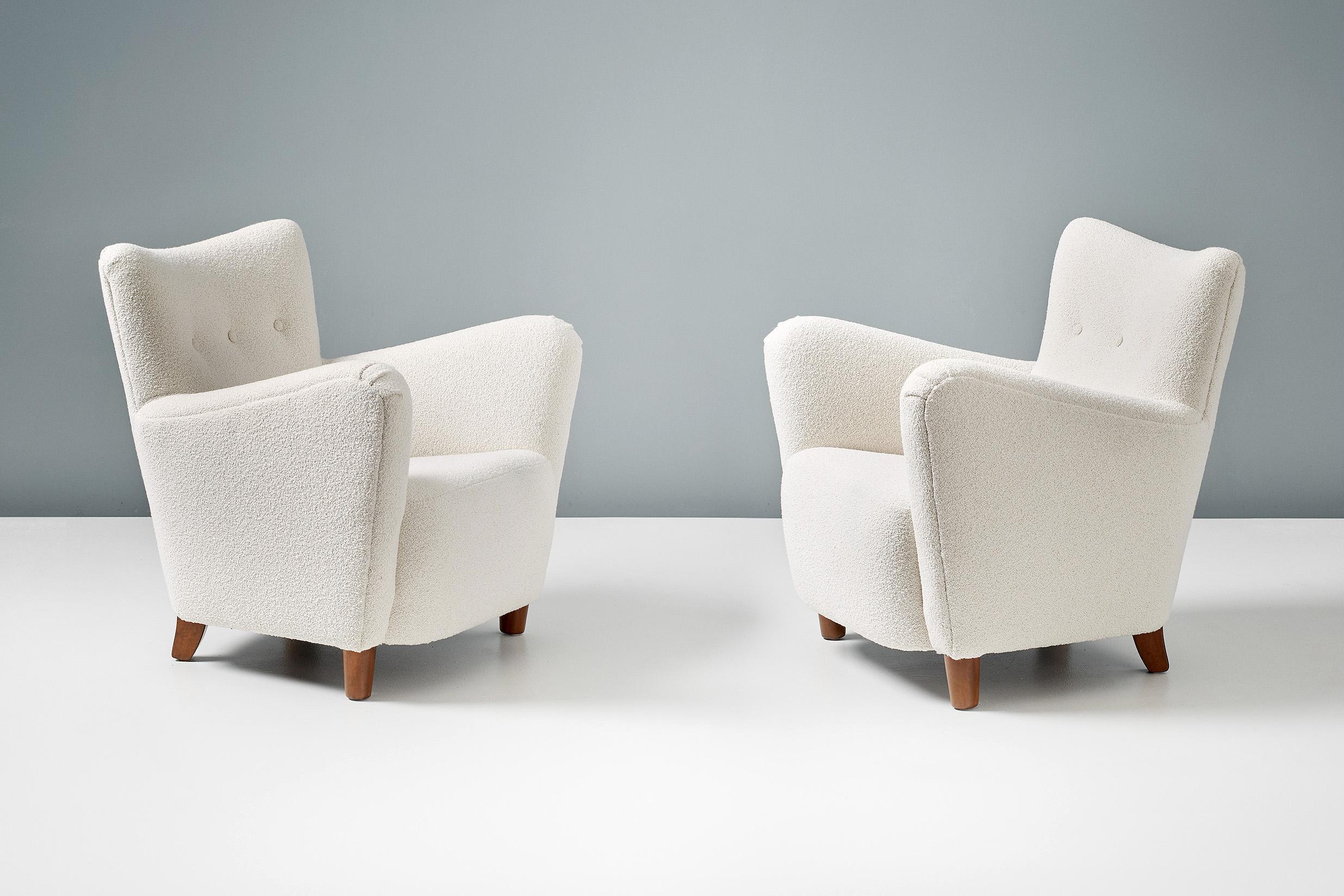 A pair of Danish cabinetmaker 1950s lounge chairs reupholstered in luxurious cotton-wool blend off-white bouclé fabric from Chase Erwin in England.

This pair of chairs were made in Denmark in the 1950s in the manner of Fritz Hansen. The legs are