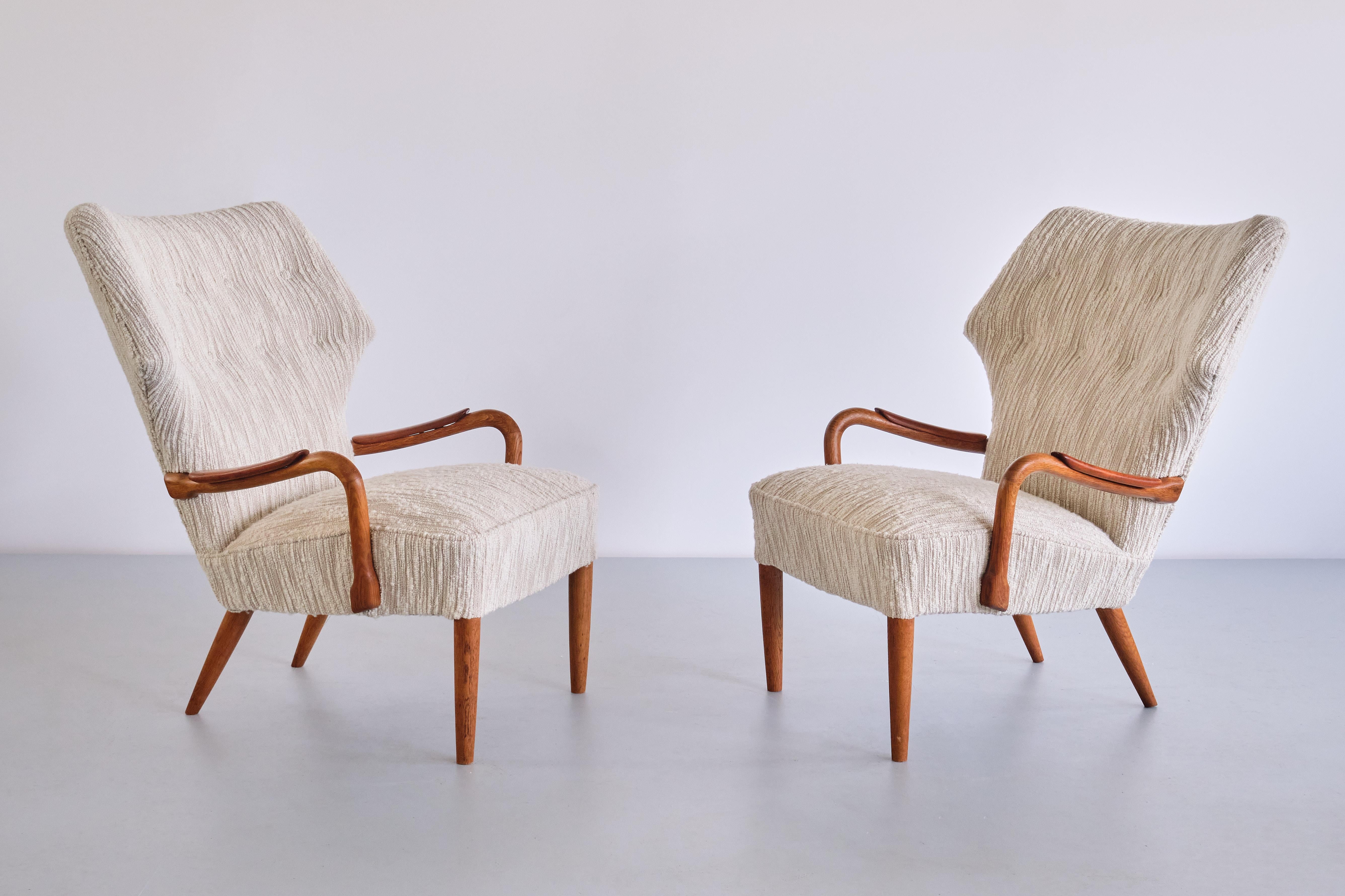 This rare set consisting of two armchairs and a matching stool were produced by a Danish cabinetmaker in Roskilde in the mid 1950s.
The design of the armchairs is marked by the slightly reclined, wing shaped back with buttoned upholstery details.