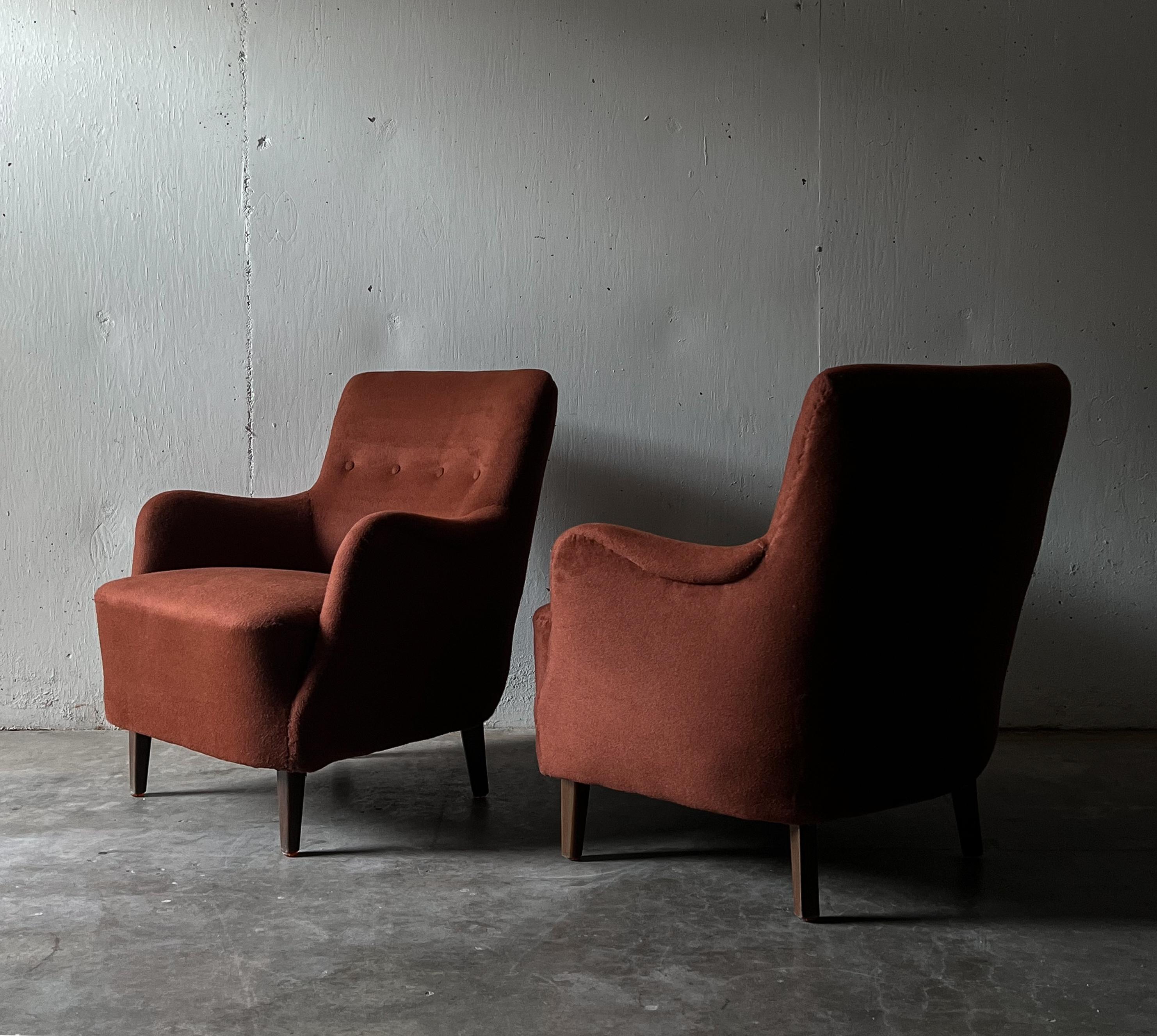 Pair of Danish cabinetmaker lounge chairs Upholstered in a Burnt Orange Alpaca Fabric.