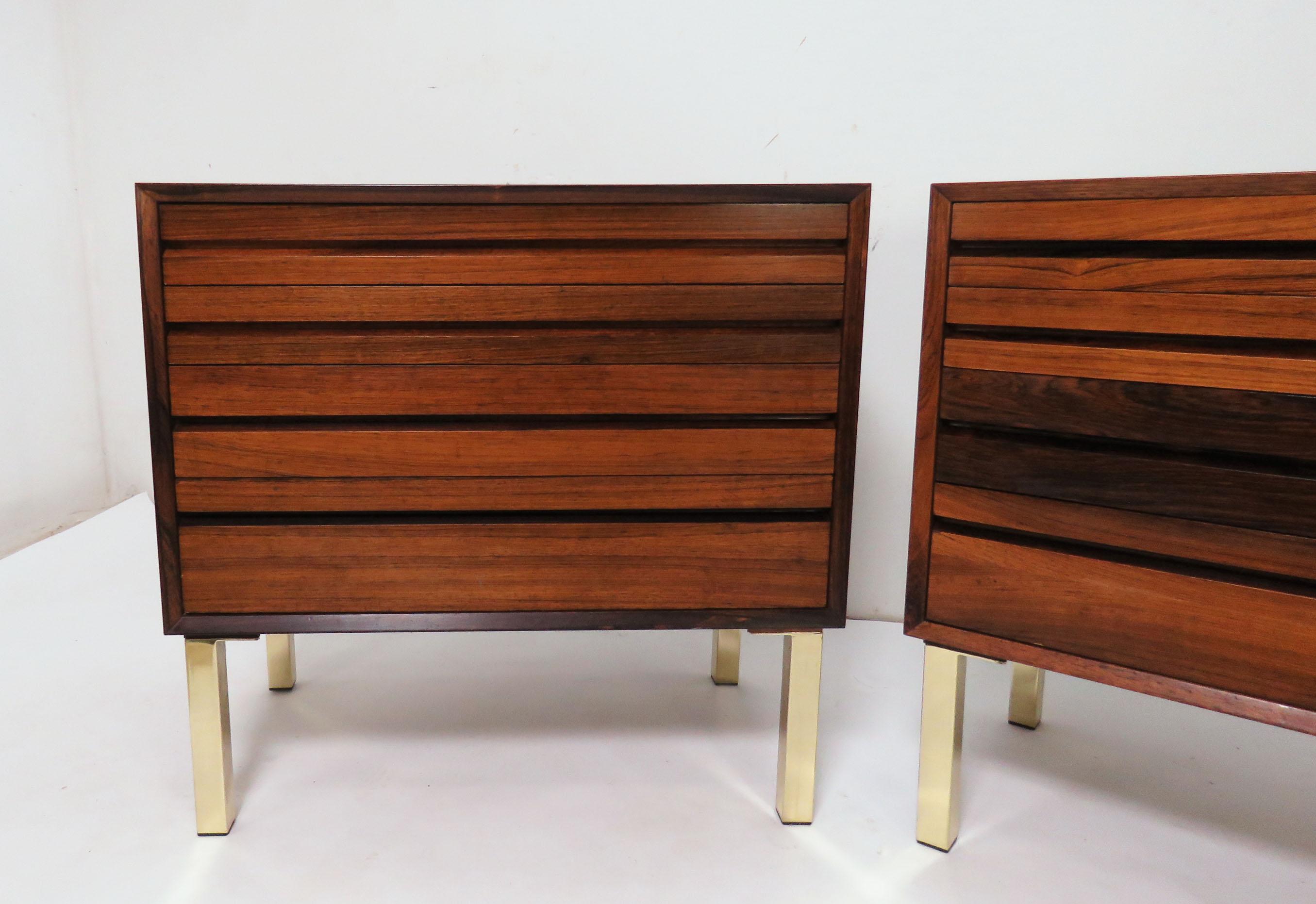 A pair of Danish rosewood Cado unit wall cabinets, mounted with aftermarket brass legs as a splendid pair of four drawer chests.

18 1/8