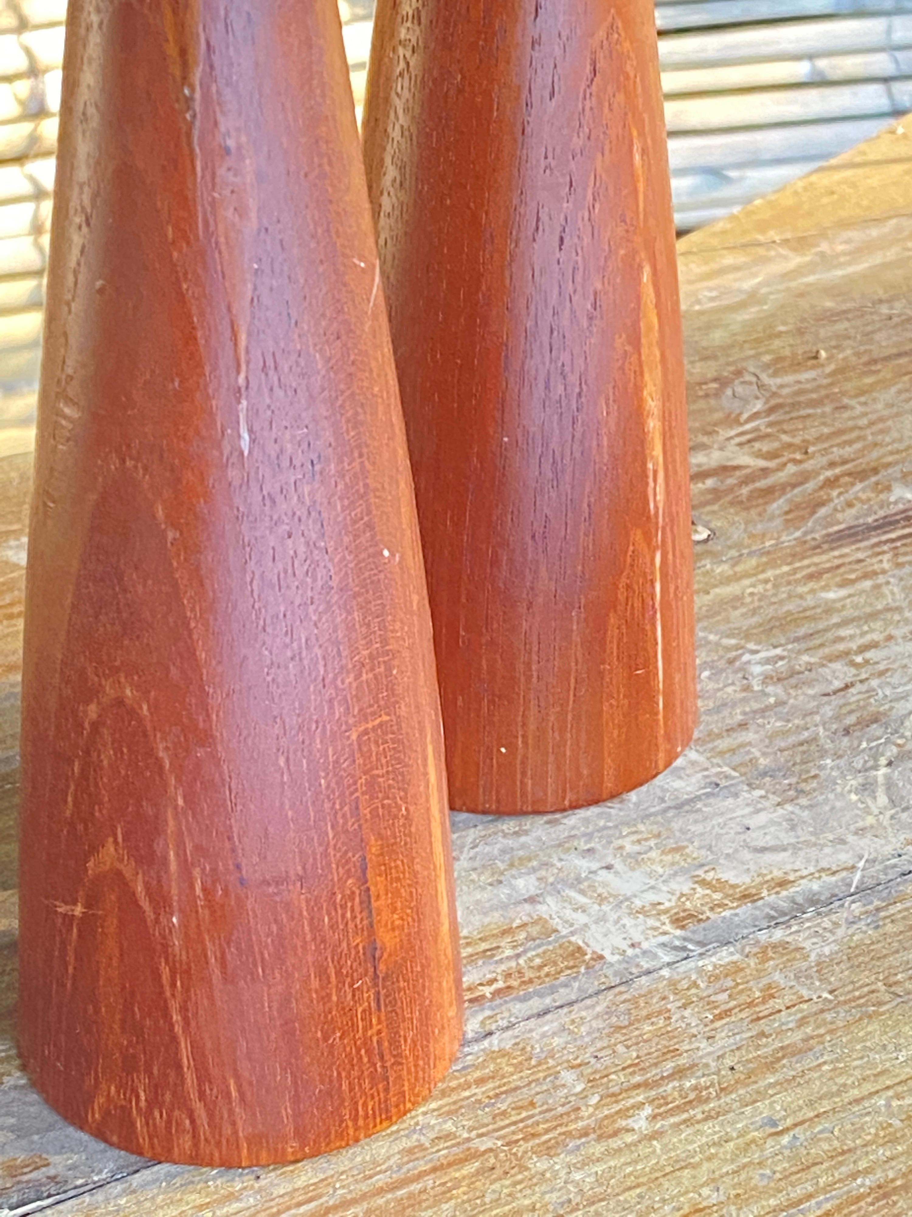 This pair of candle holder, has been made in Denmark around 1950. They are in Wood, more precisly in Teak. The color is brown, and they are signed DISMED DENMARK.