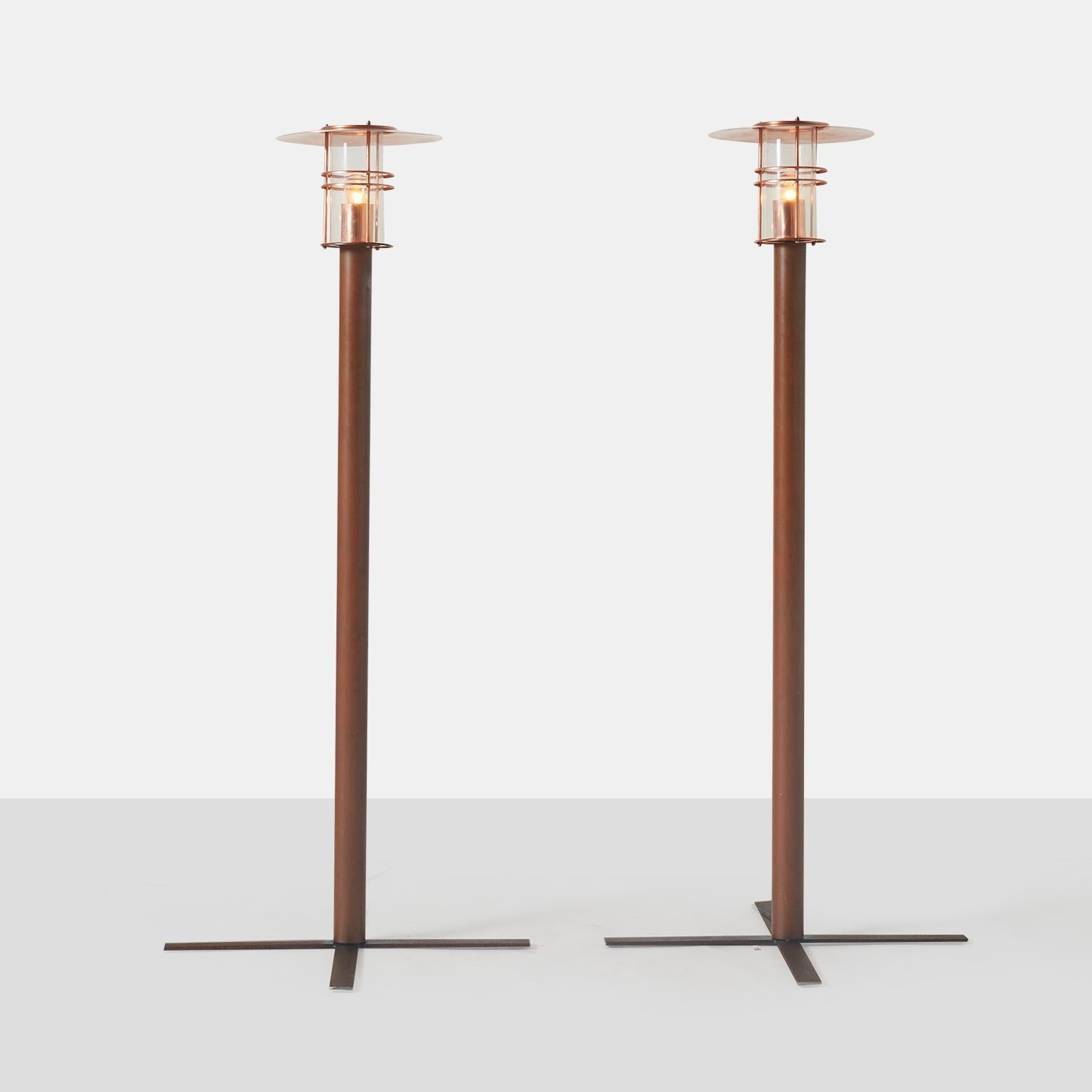 A pair of copper outdoor or sidewalk lamps The light fixture has been restored to remove some previous denting, and the copper is bright and shiny. There is some attractive oxidization to the upright post. It appears the lamps were never installed