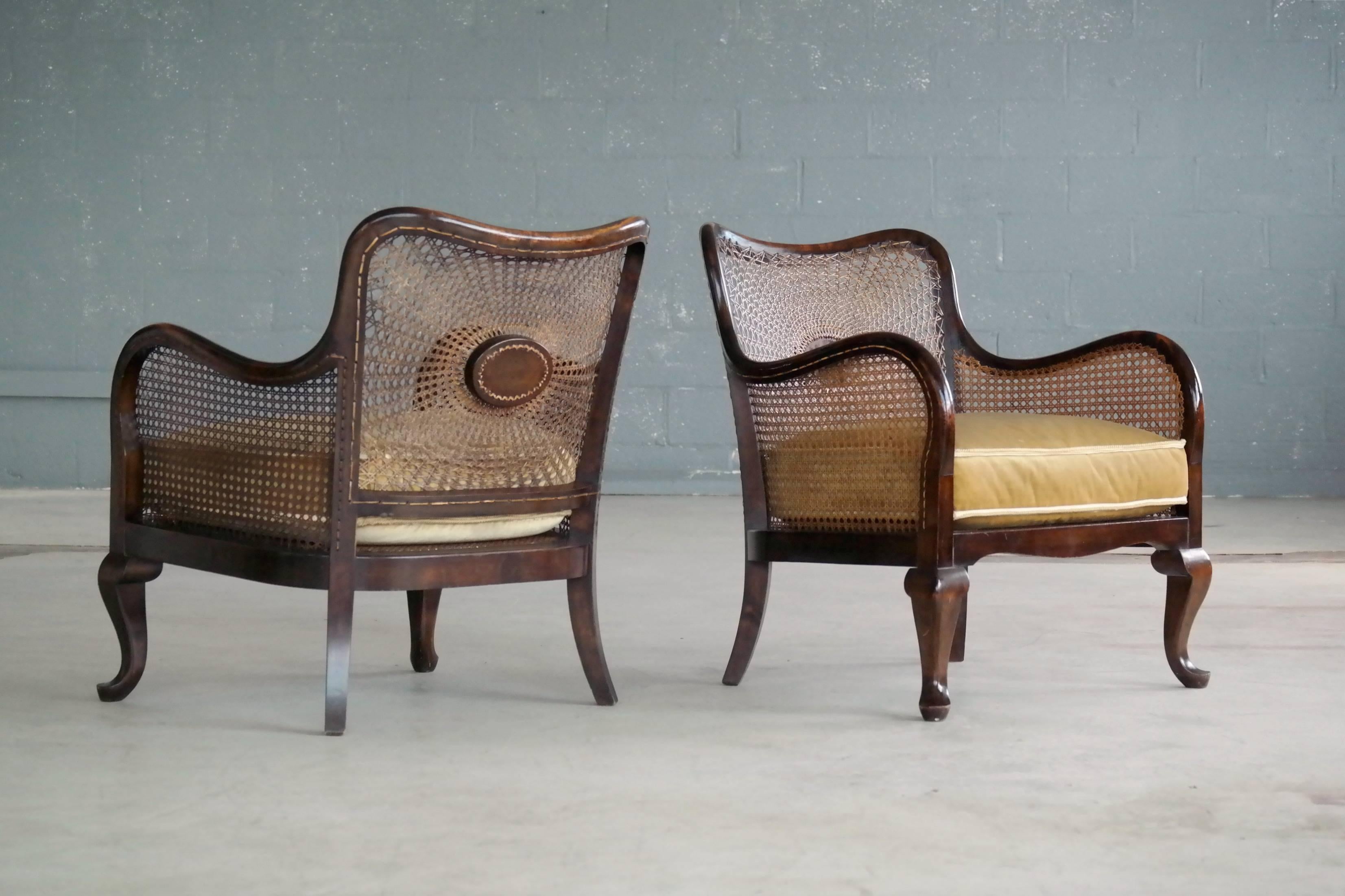 Very elegant and simple lines yet exuberant execution of detail. We found these art nouveau period caned bergeres handwoven in a spider pattern with mohair velvet cushions in Denmark. Made from stained birch and woven cane in the early part of the