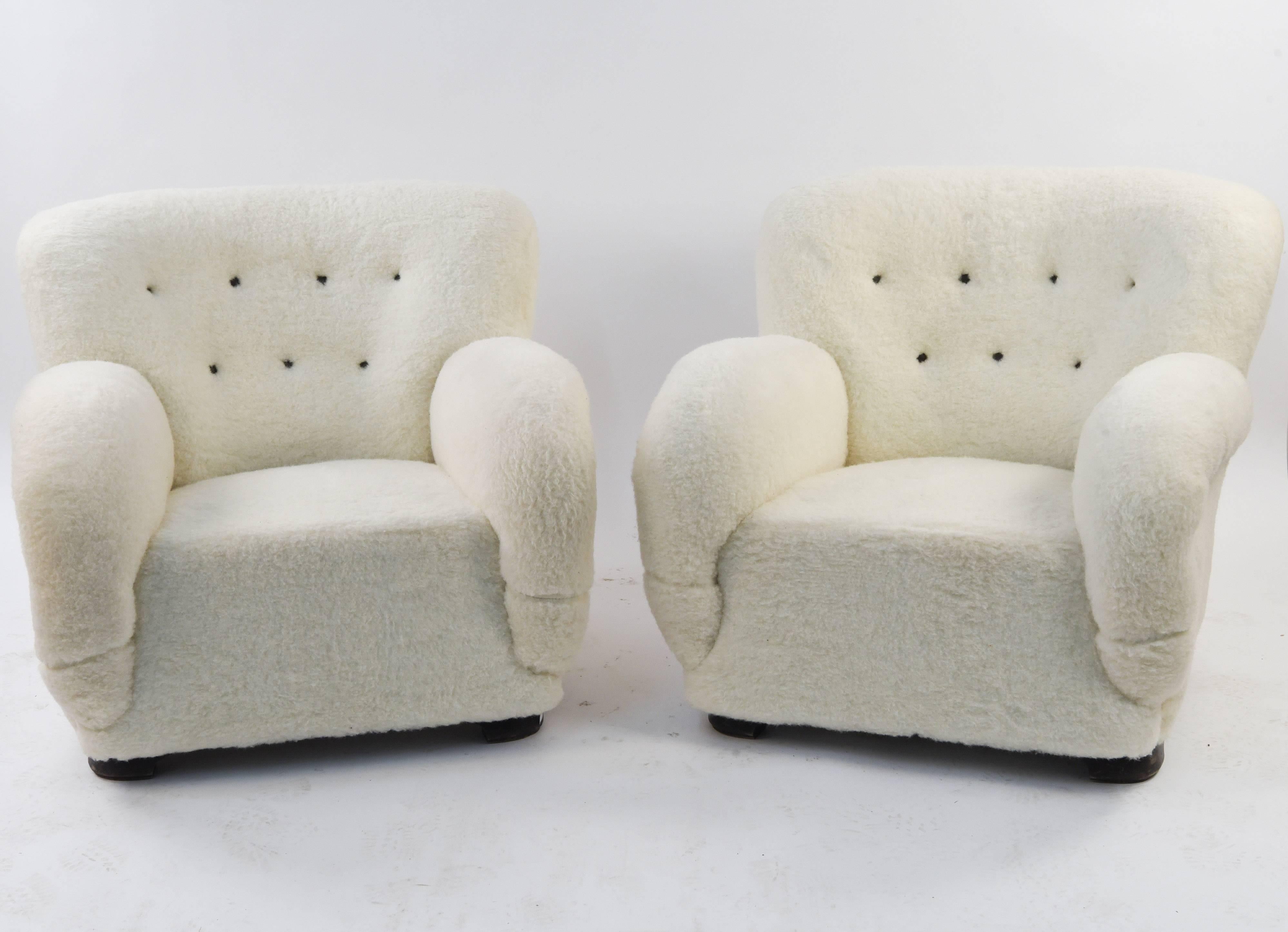 This is an incredible pair of Danish easy chairs recently upholstered in lambs wool, circa 1940s. These will capture full attention as a statement piece. Comfortable and stylish.