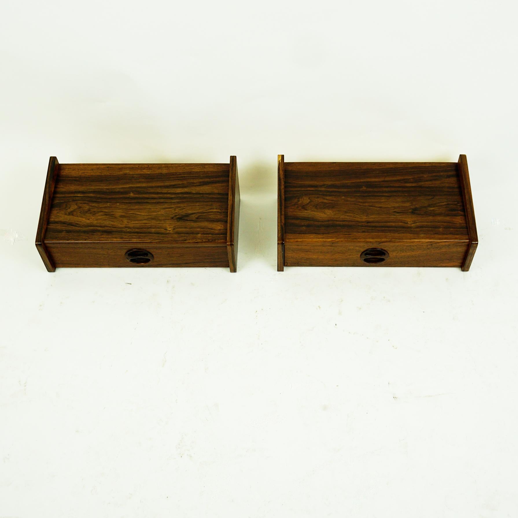 Charming small floating Danish rosewood nightstands ore shelves from the 1950s with a simple streamline design, featuring one drawer each. They can be used as a nightstand or as well in the wardrobe. Authentic example for Danish modern design from